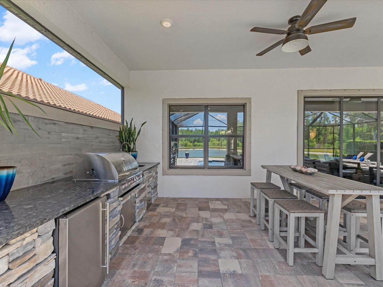 Outdoor kitchen with sink and mini refrigerator