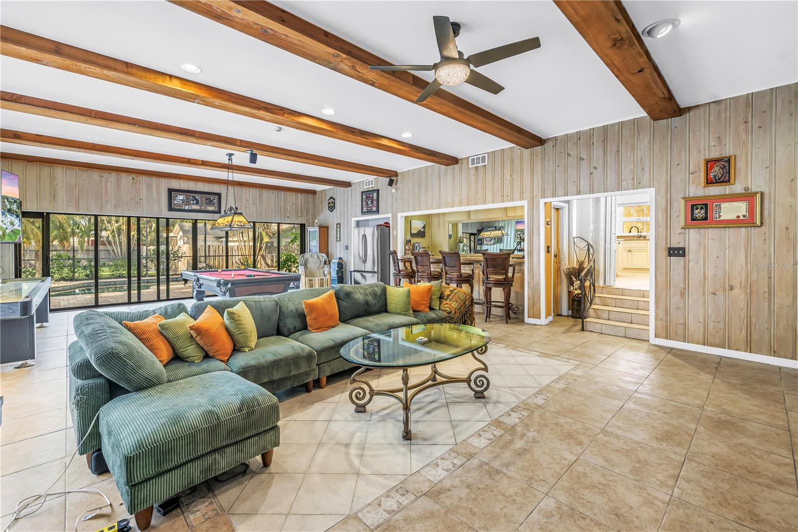 Huge family room with wood beams and durable tile for entertaining
