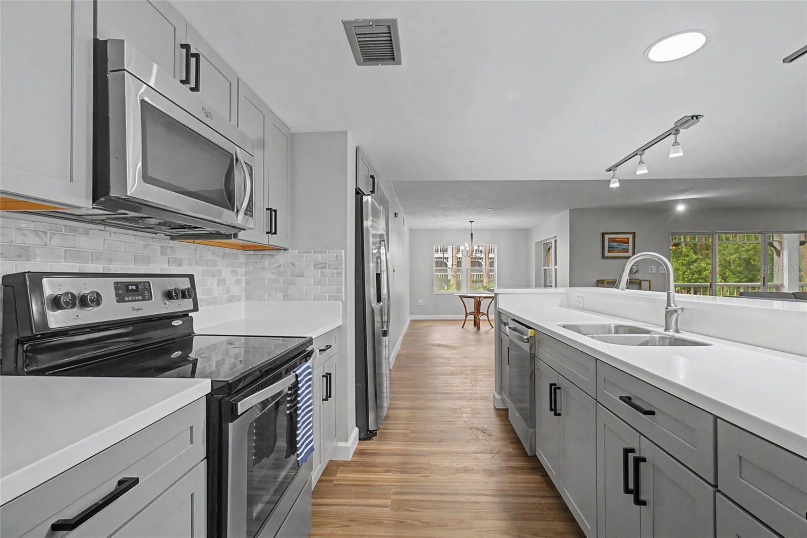 Kitchen with Breakfast Bar, ample room for a Buffet Table, etc. Open to Living Room/Dining Room