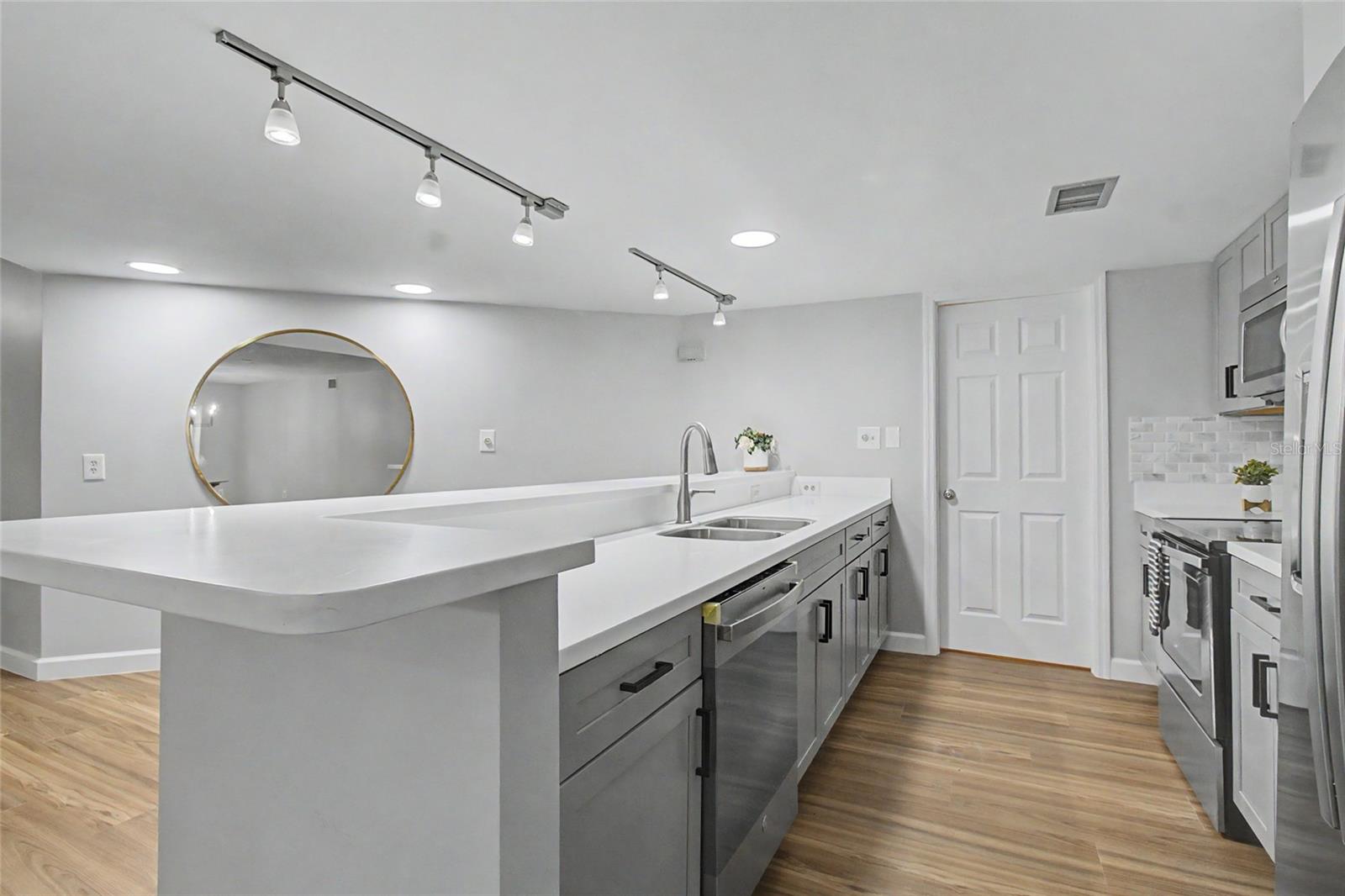 Kitchen with Breakfast Bar, ample room for a Buffet Table, etc. Open to Living Room/Dining Room