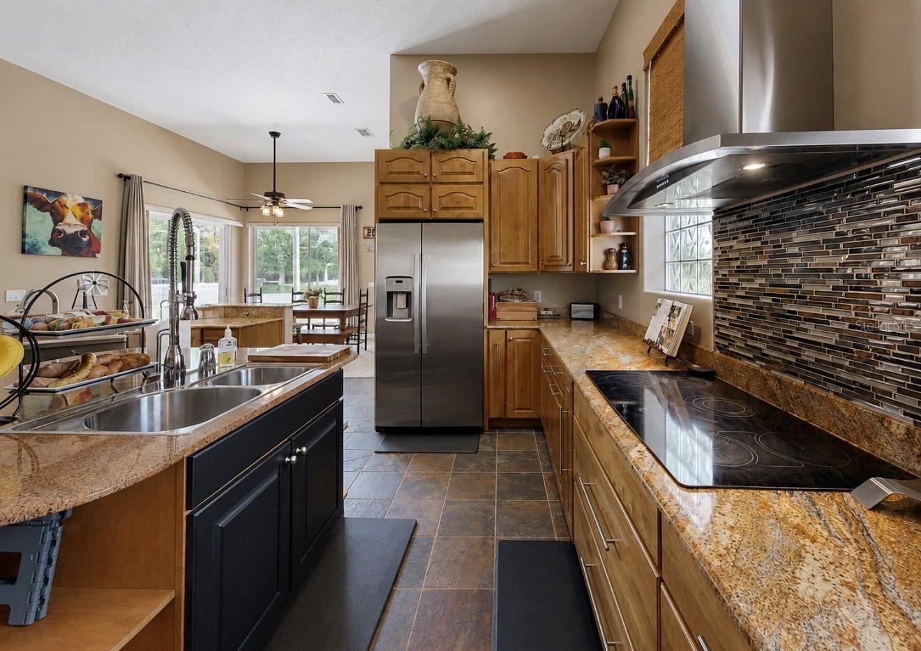 Kitchen with custom stainless appliances, dual fridges