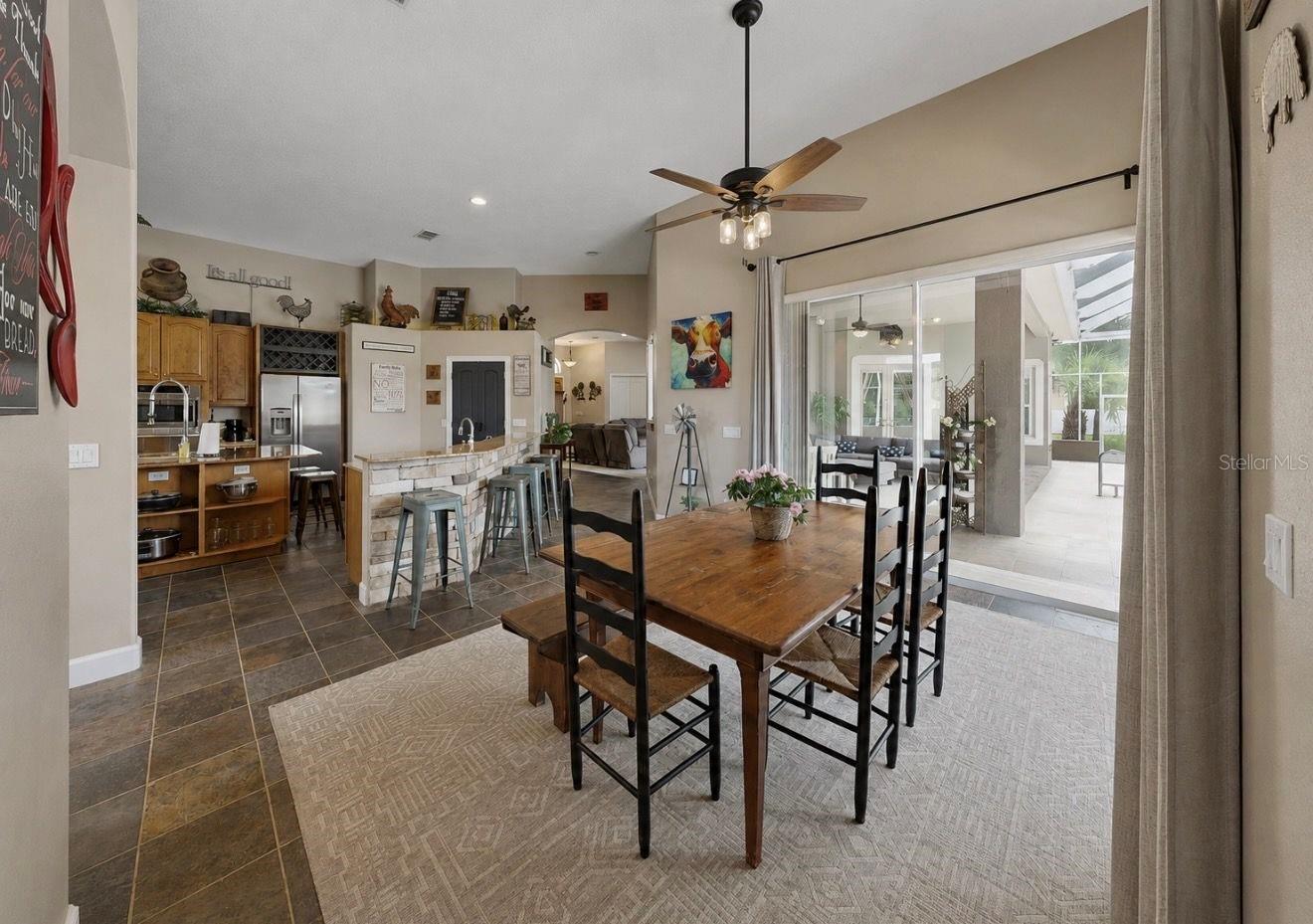 Dining room with sliders to pool