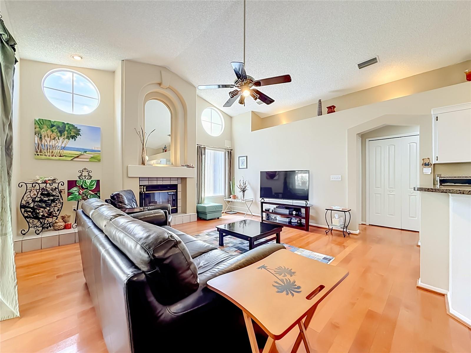 Family room with wood burning fireplace and plenty of Natural Light!