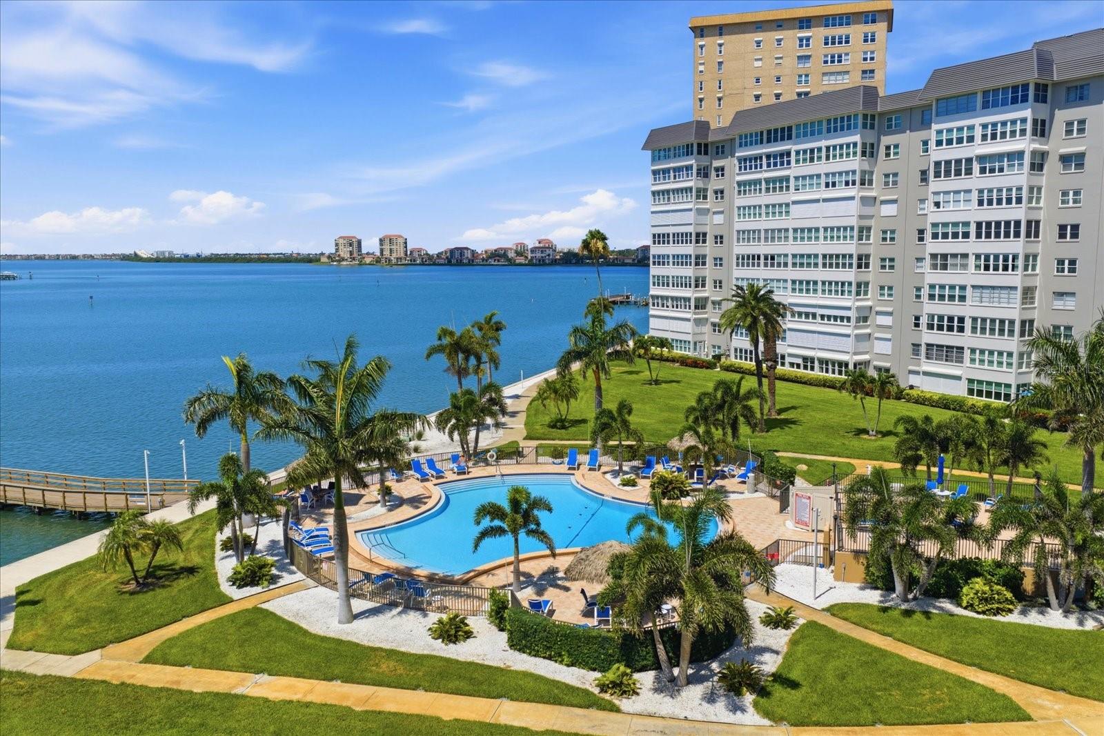 Tropical island setting and expansive water views are yours to enjoy from this spacious 1,605 Sq Foot Point Brittany condo with impact windows being sold fully furnished/turnkey.