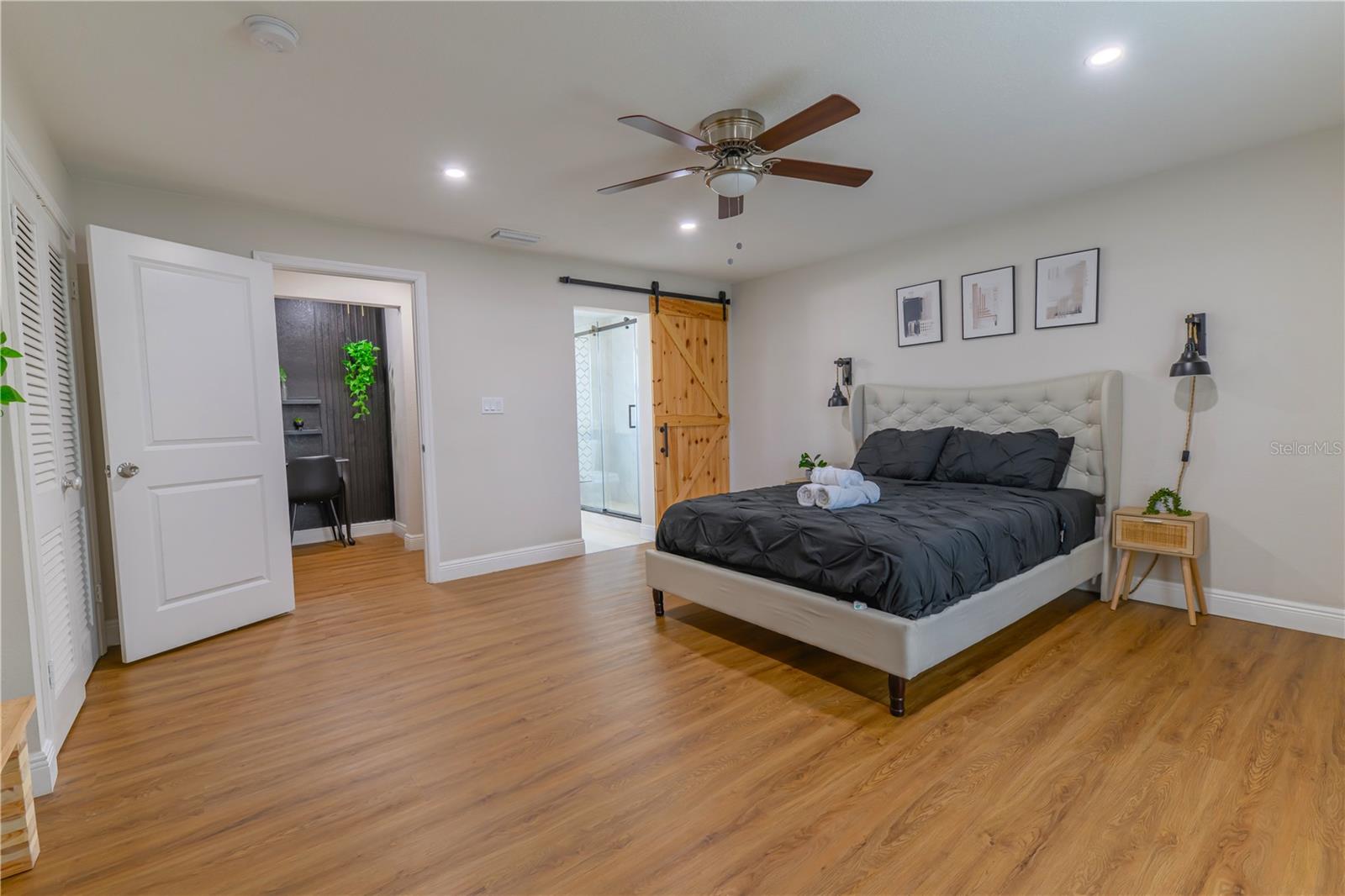 Primary Bedroom, Entryway, Barn Door into Ensuite Bathroom with Shower, & Ceiling Fan