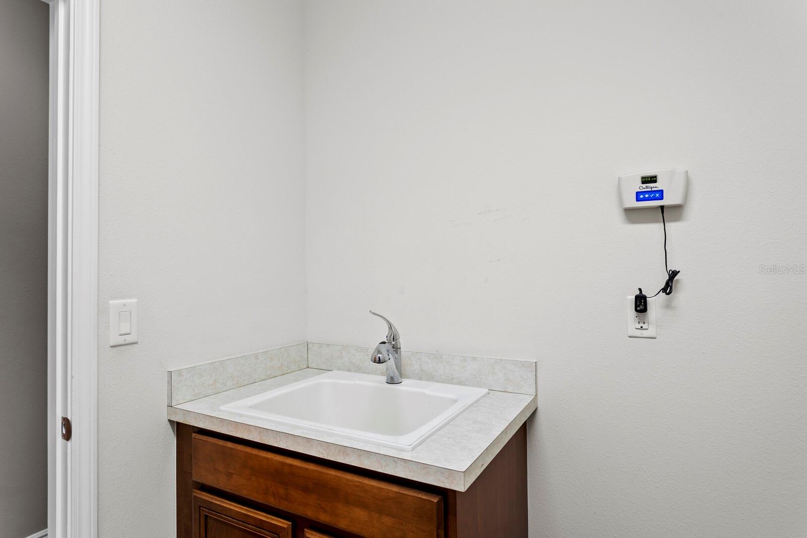 Utility sink in utility room & access to 3-car garage