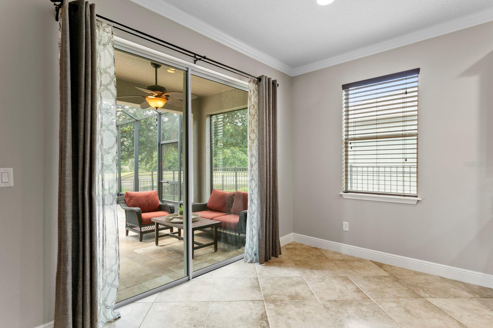 Casual dining area with slider access to screened lanai