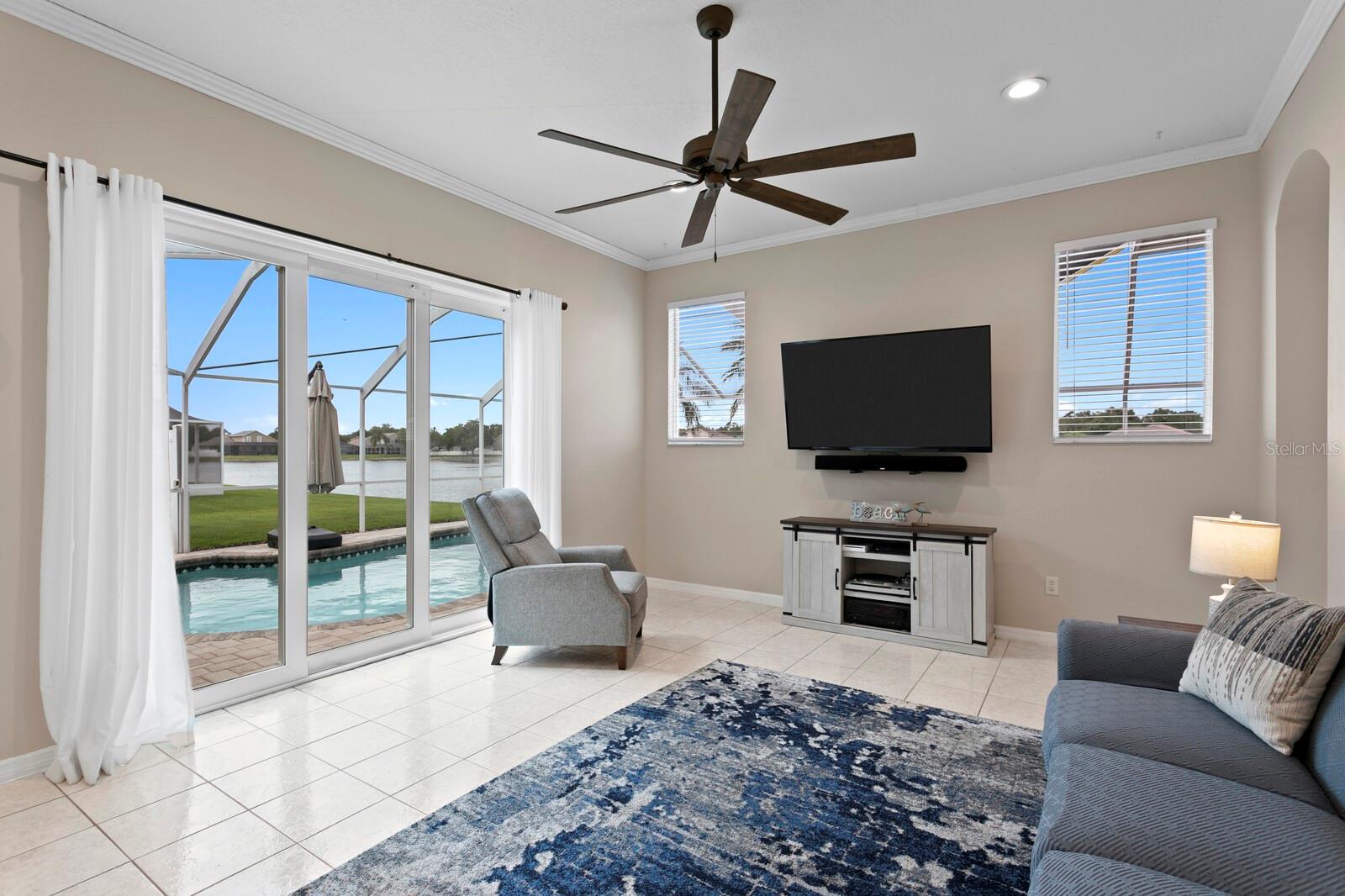 Triple sliding glass doors from family room out to the pool
