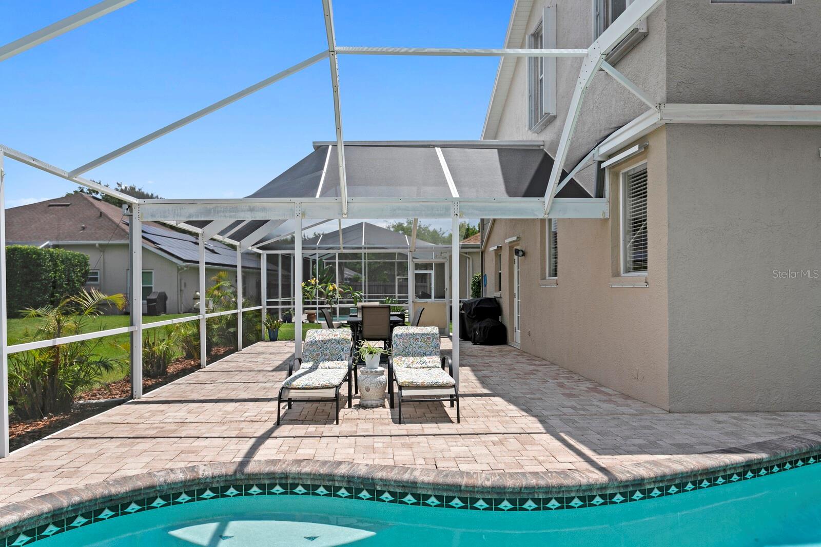 Wrap-around screened lanai and paver deck for more outdoor living space