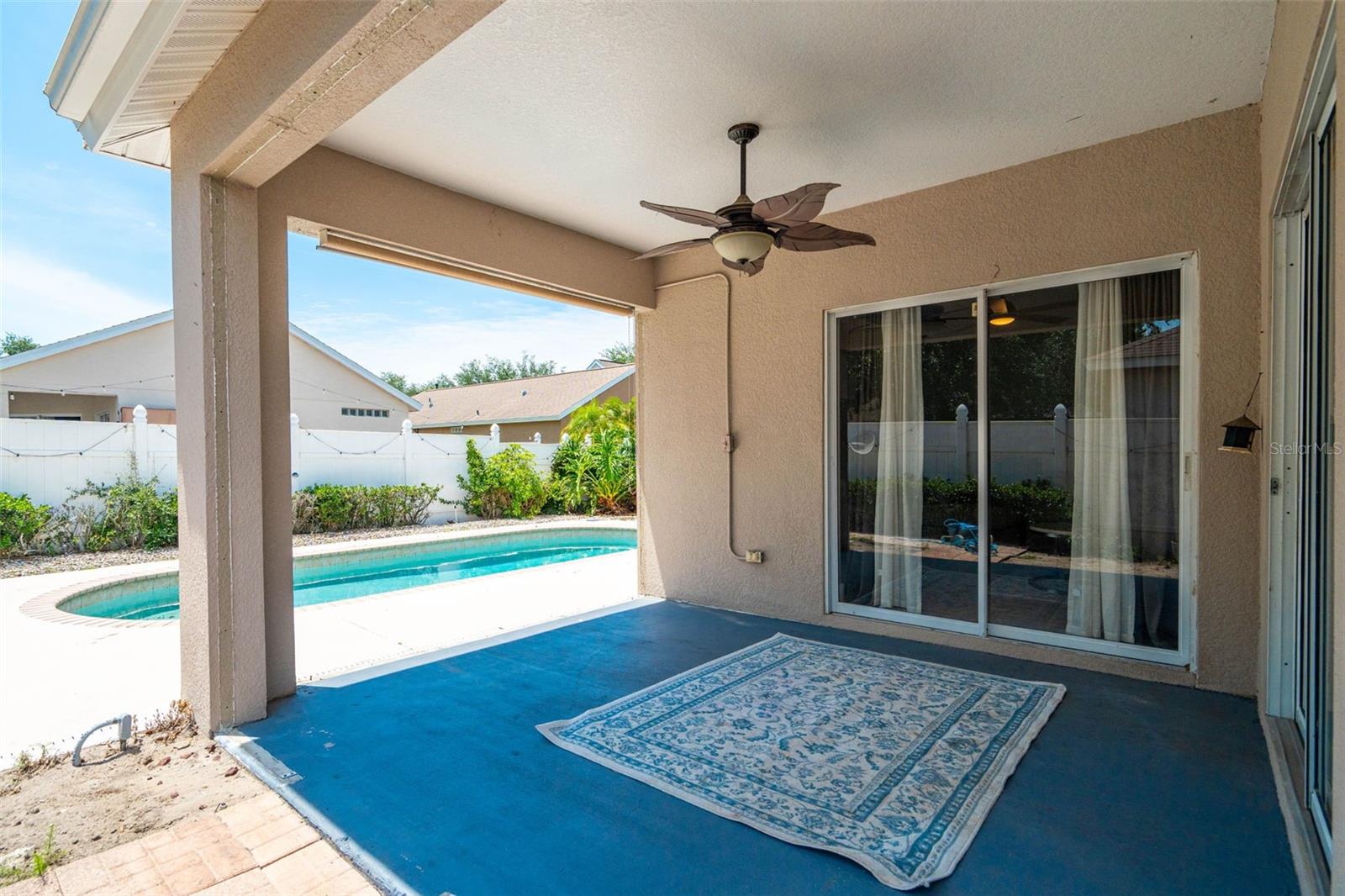 Outdoor patio accessible from formal living and family rooms through sliding doors.