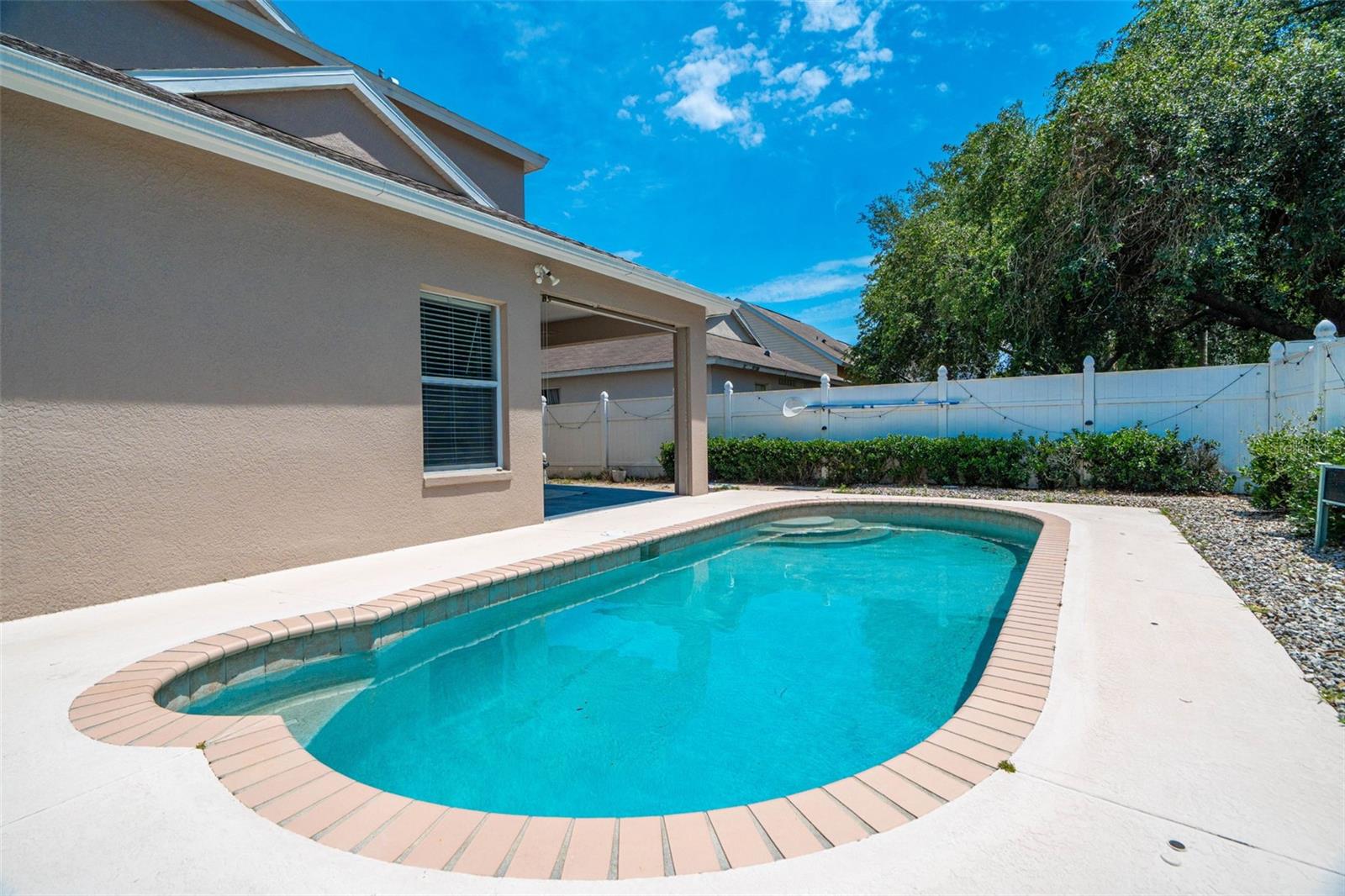 Fully fenced backyard with beautiful pool.