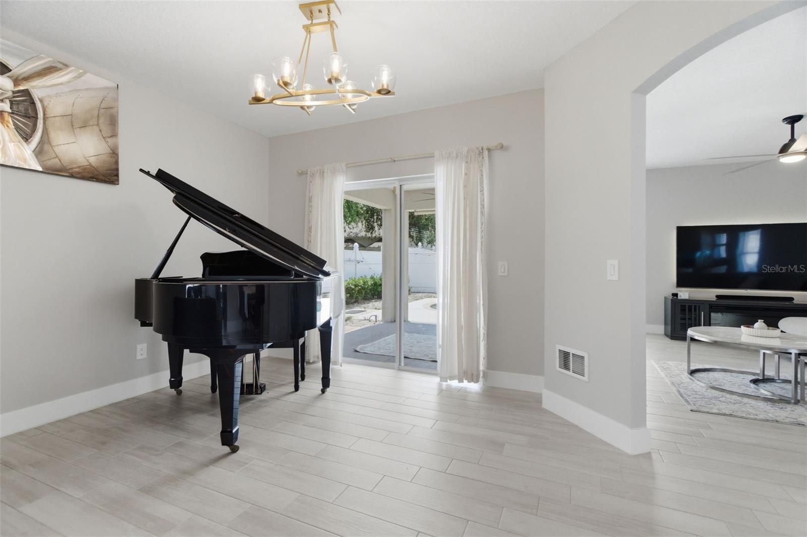 Formal living room leads to pool through sliding doors