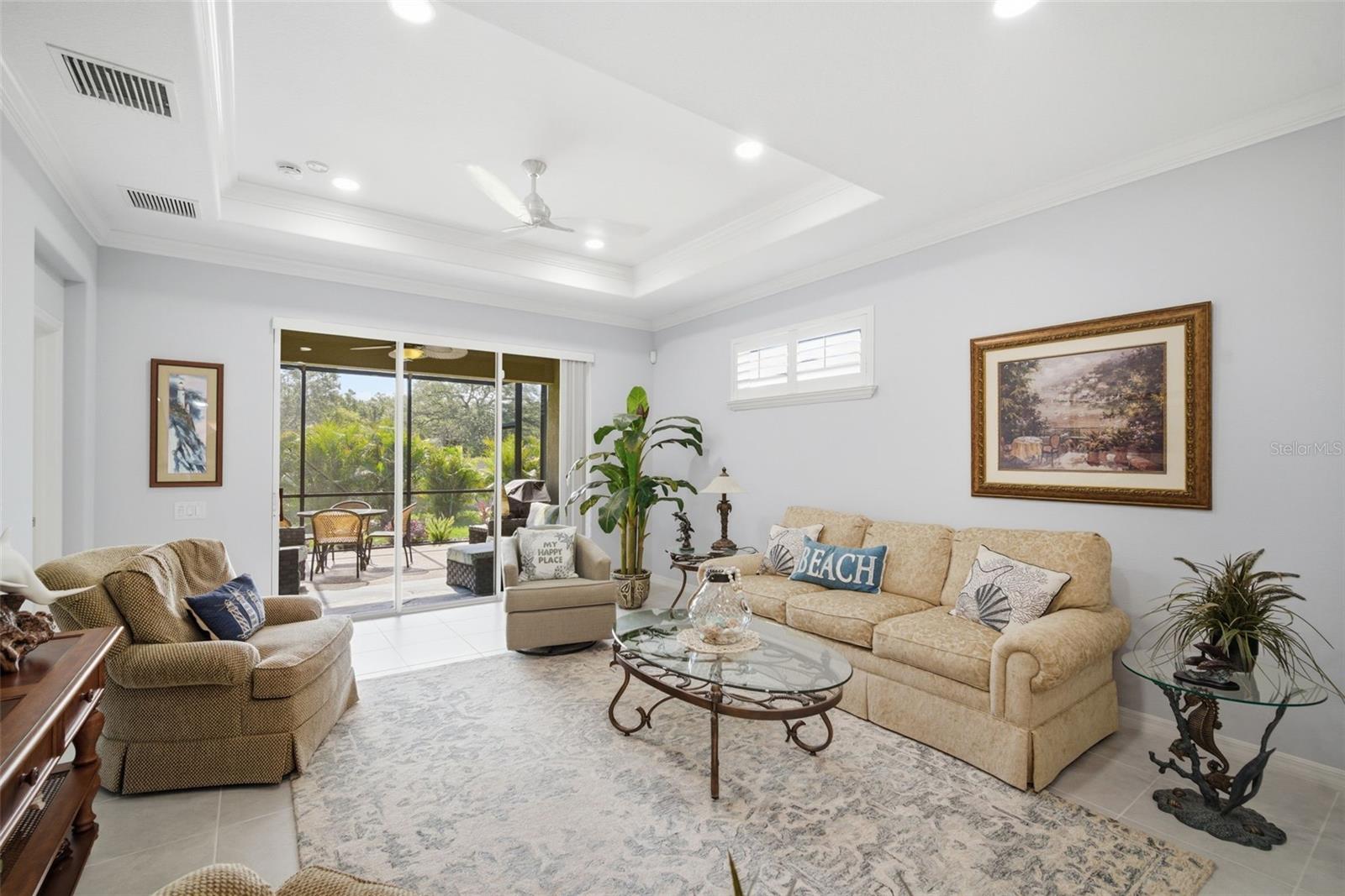 COFFERED CEILING AND SUNSHINE HIGHLIGHT THE LIVING ROOM