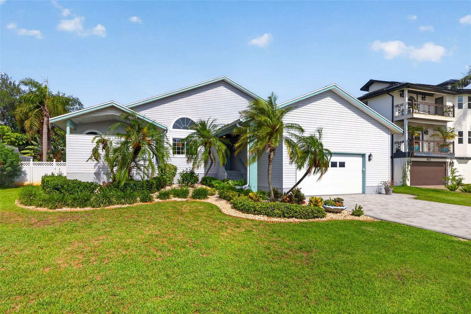 Nicely landscaped with freshly painted trim and new driveway pavers