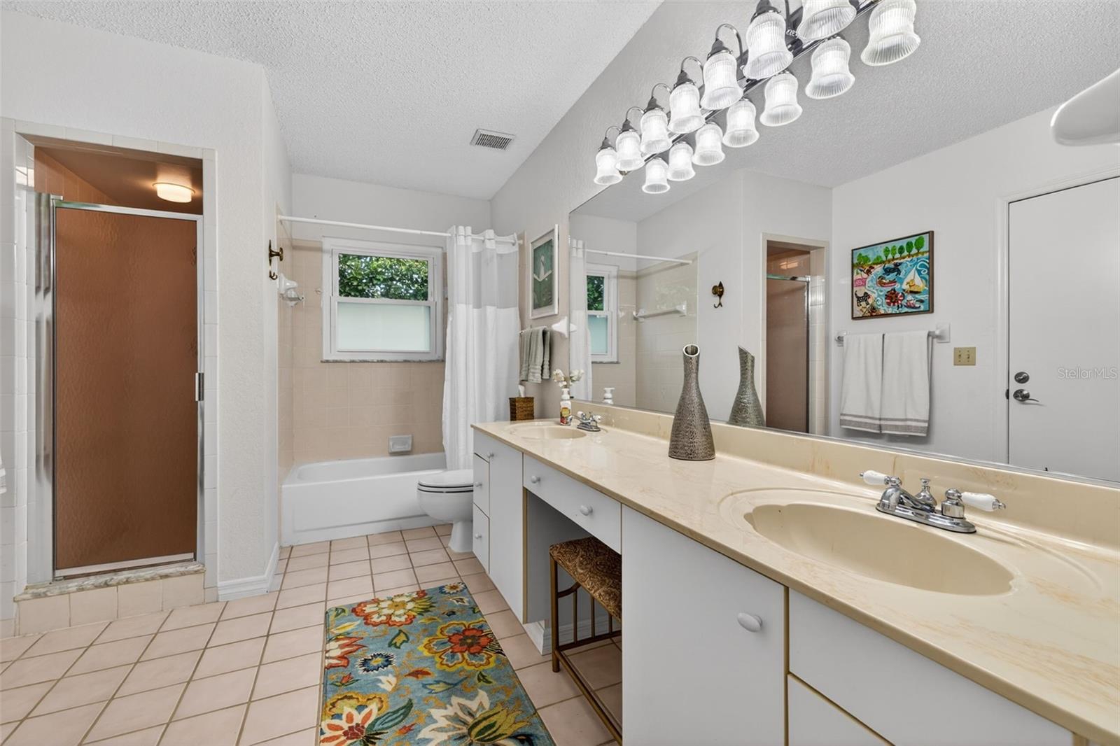 Extra-large secondary bath not only offers 2 sinks, but 2 showers as well. An exterior door leads to the covered back porch to serve as a future pool bath