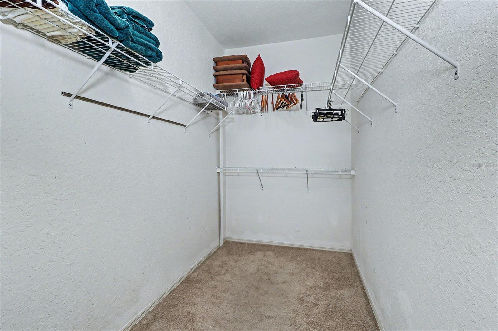 Primary bedroom walk in closet
