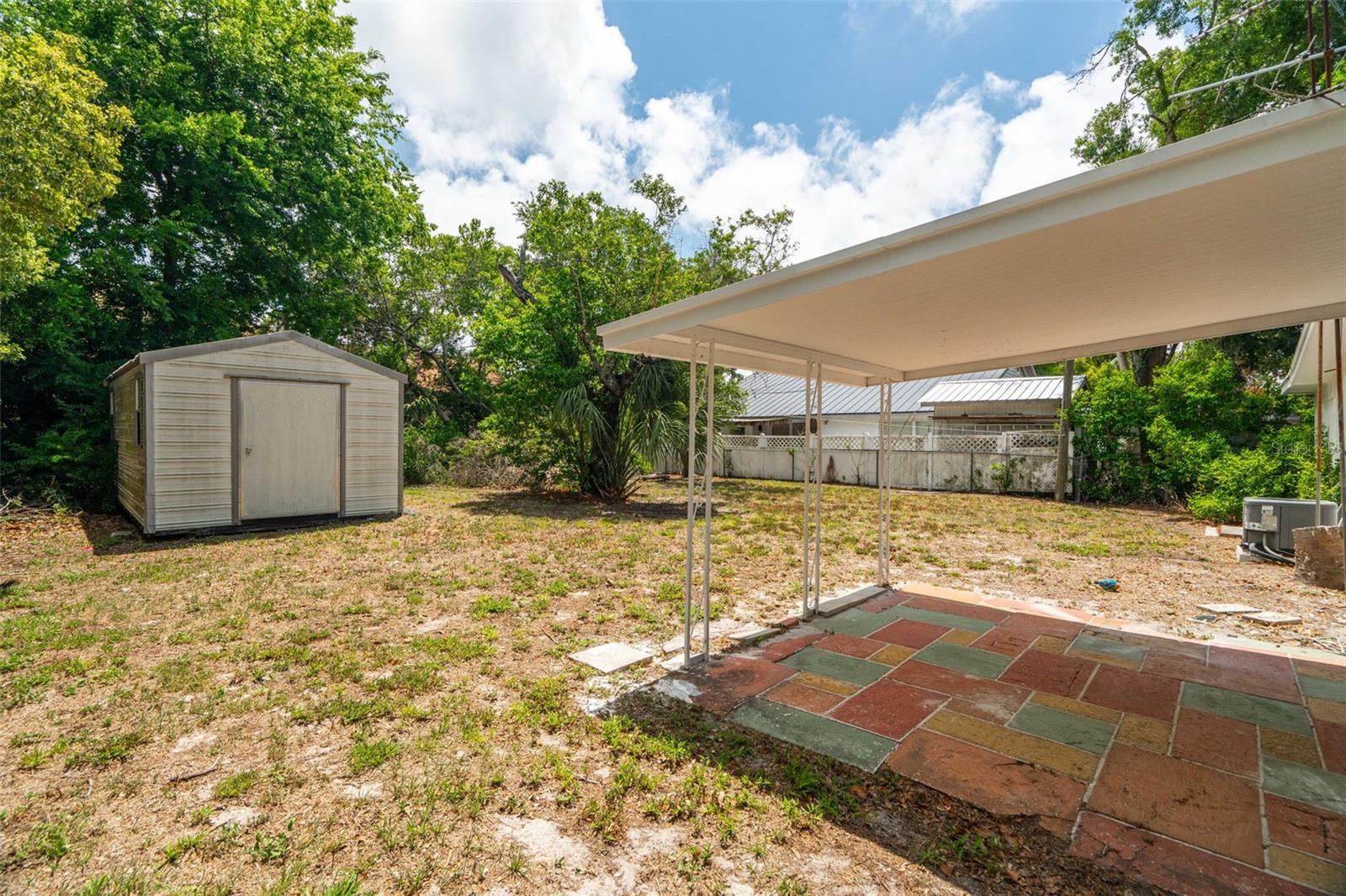 Back yard with covered living area and shed