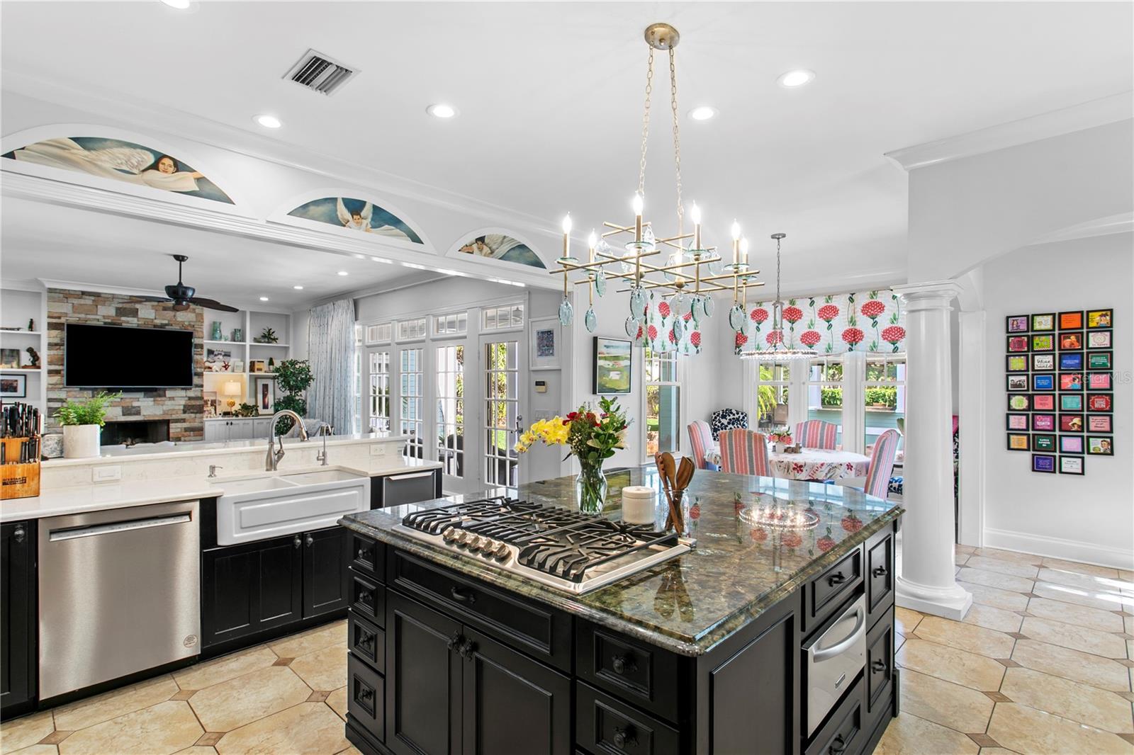 With expansive windows and an open layout, the kitchen offers clear views of both the living room and backyard