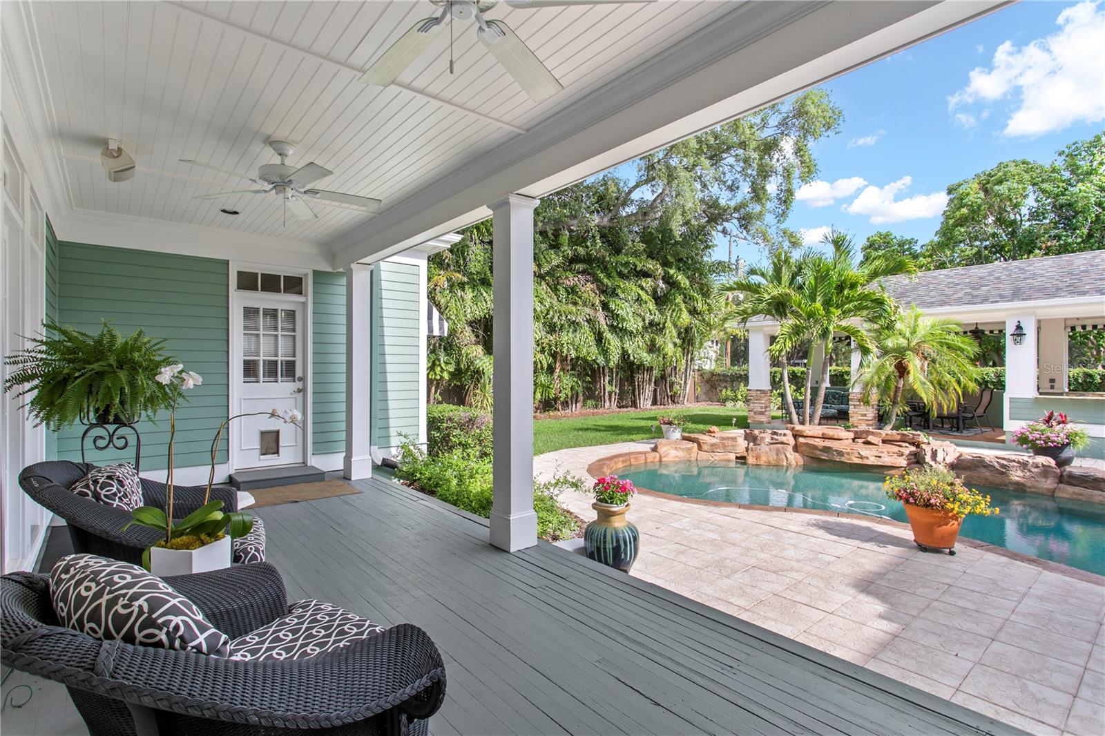 Seamlessly connected, the living room opens to the back porch and backyard space.