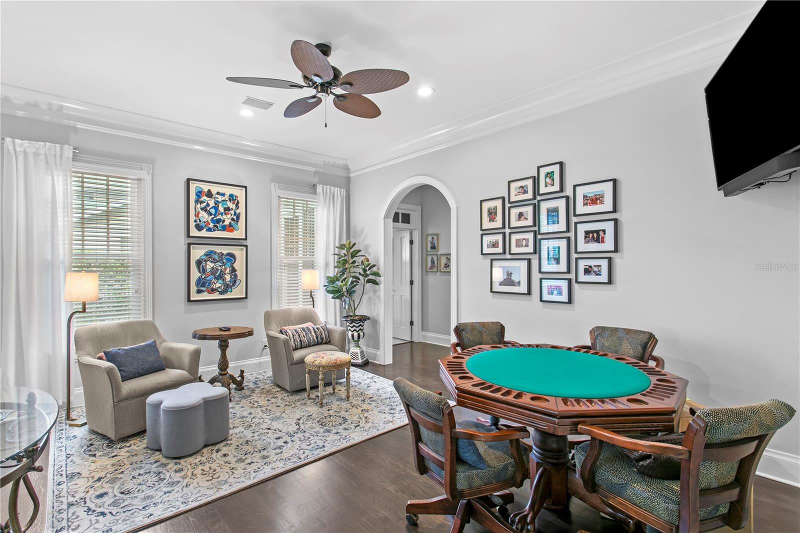 Currently used as a secondary lounge space, the formal living room is ideal for movie nights, card games, and entertaining