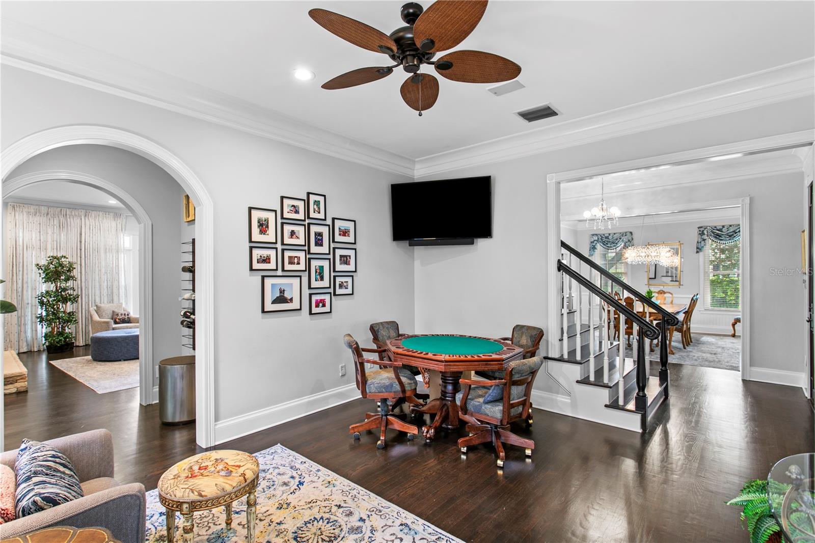 Currently used as a secondary lounge space, the formal living room is ideal for movie nights, card games, and entertaining