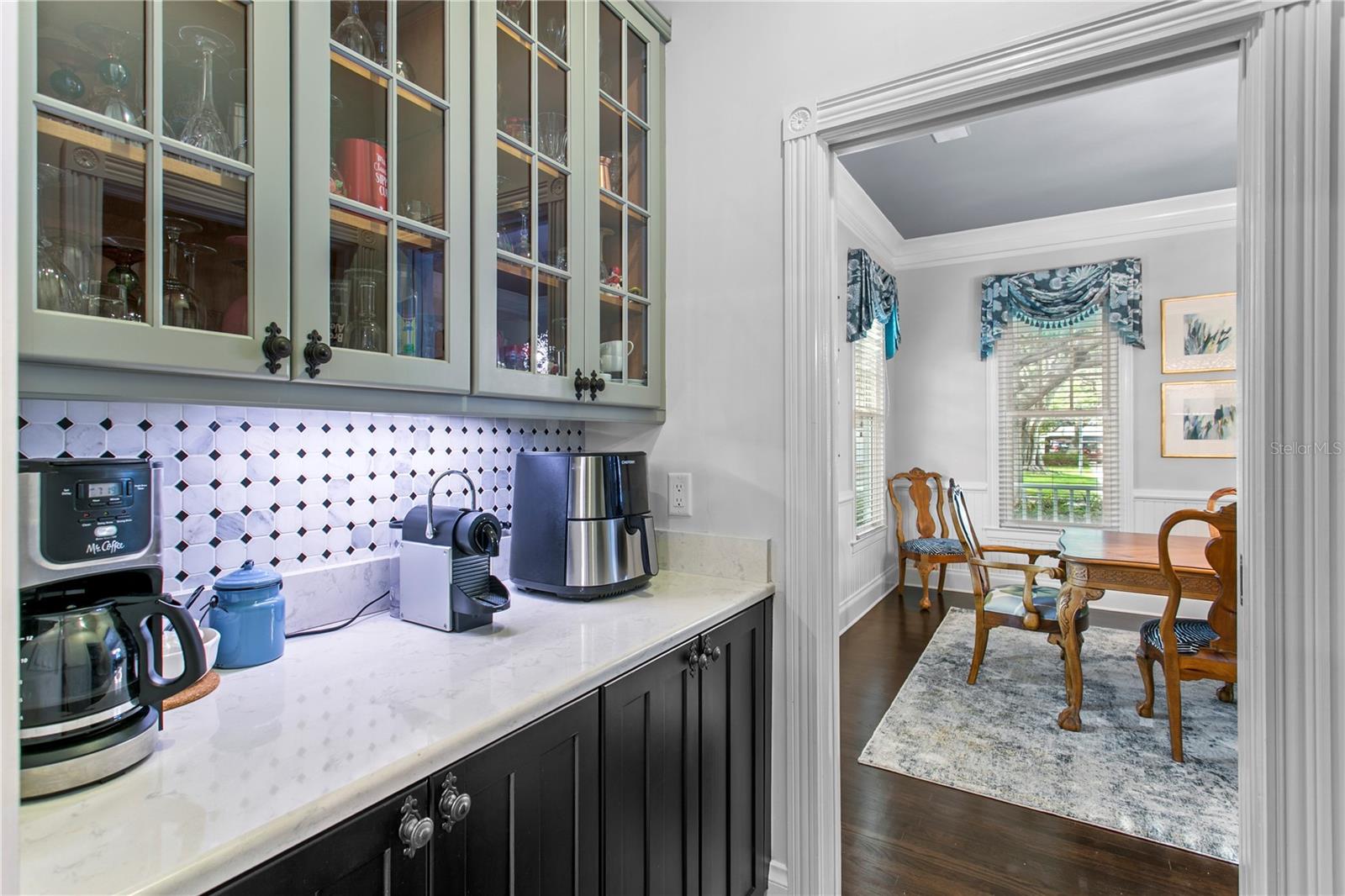Enjoy added convenience with a dry bar off the dining room, perfect for entertaining or your morning coffee routine which connects to the kitchen