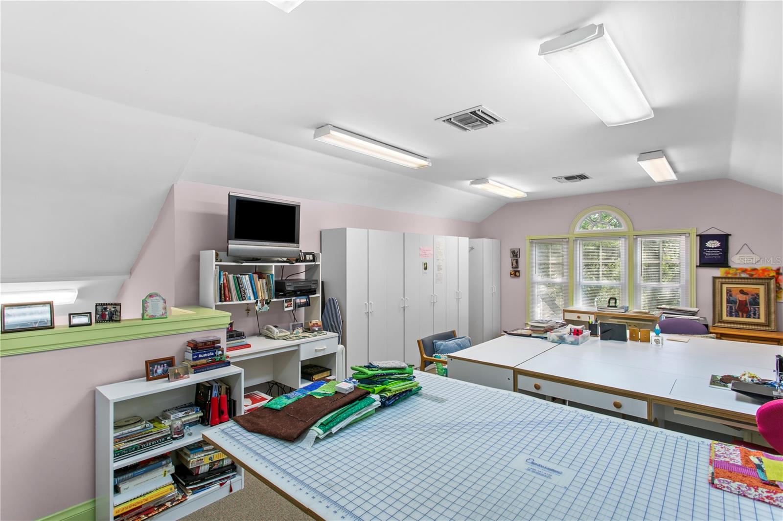 The third level offers a versatile bonus room currently designed as a sewing and arts-and-crafts studio, providing a quiet and inspiring space filled with possibilities. Whether envisioned as a home theater, private office, playroom, or creative retreat, this flexible space can easily be tailored to fit any lifestyle and evolve with the needs of its next owner.