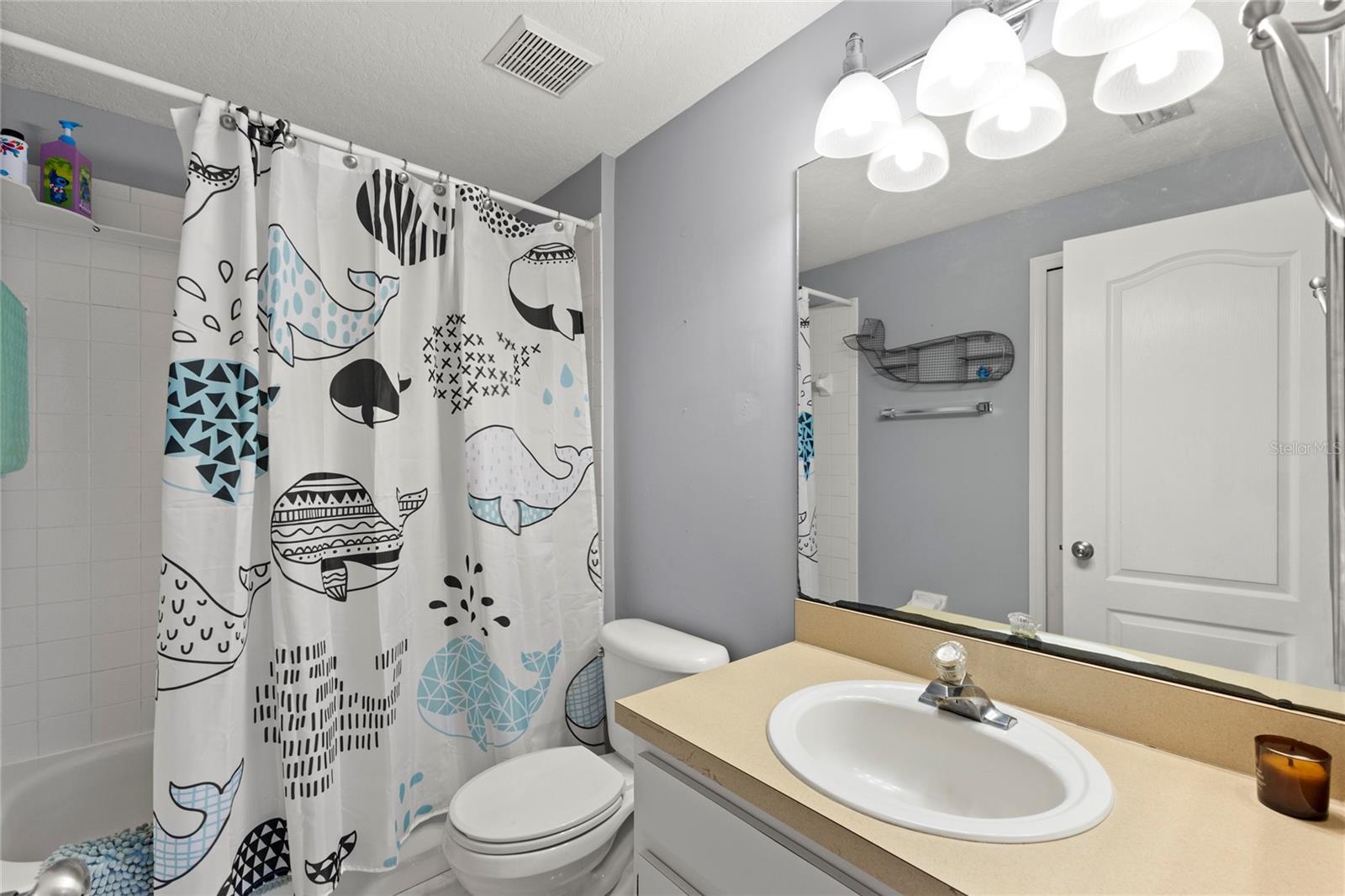 Bathroom 3Second-floor bathroom with tub/shower combination, oversized vanity mirror, single-sink vanity, contemporary vanity lighting, and neutral paint tones. Functional layout serves the adjoining bedrooms and loft area.