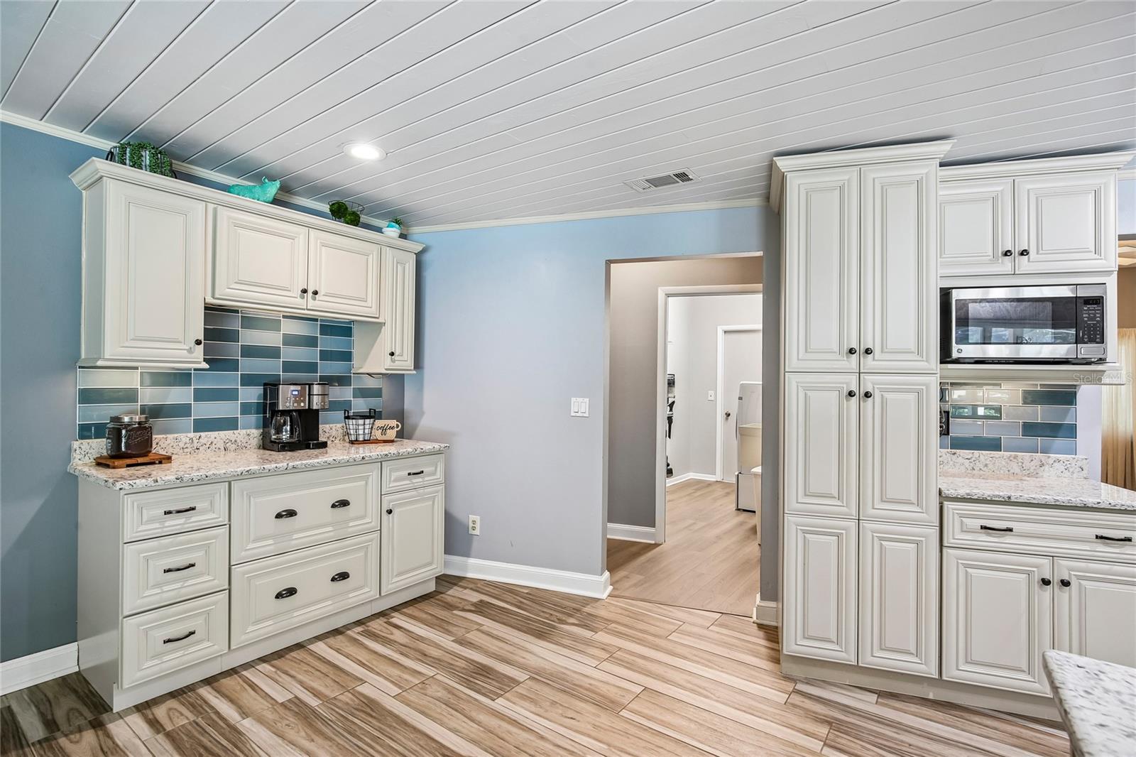 Coffee bar off the dinette area and view of the panty and additional cabinets
