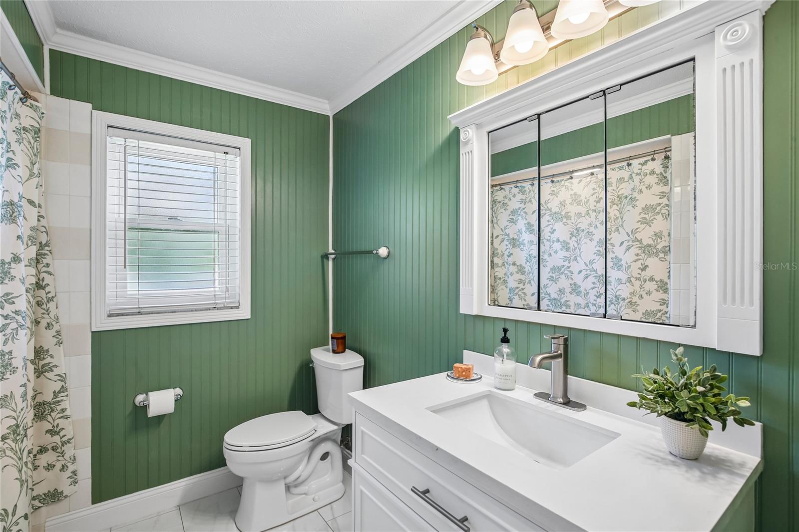 Renovated Bathroom with new vanity, marble floors, bead board, fixtures and shower