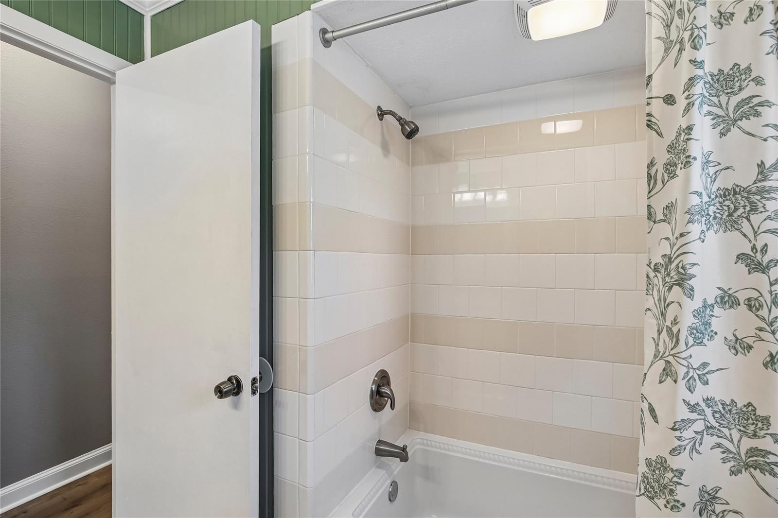 Renovated Bathroom with new vanity, marble floors, bead board, fixtures and shower