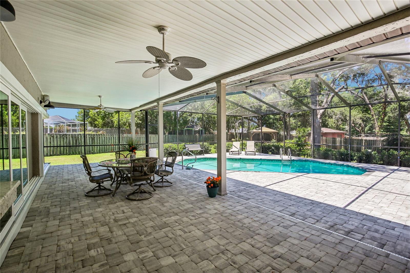Gorgeous Lanai with stunning pavers.  Look at the back yard oasis