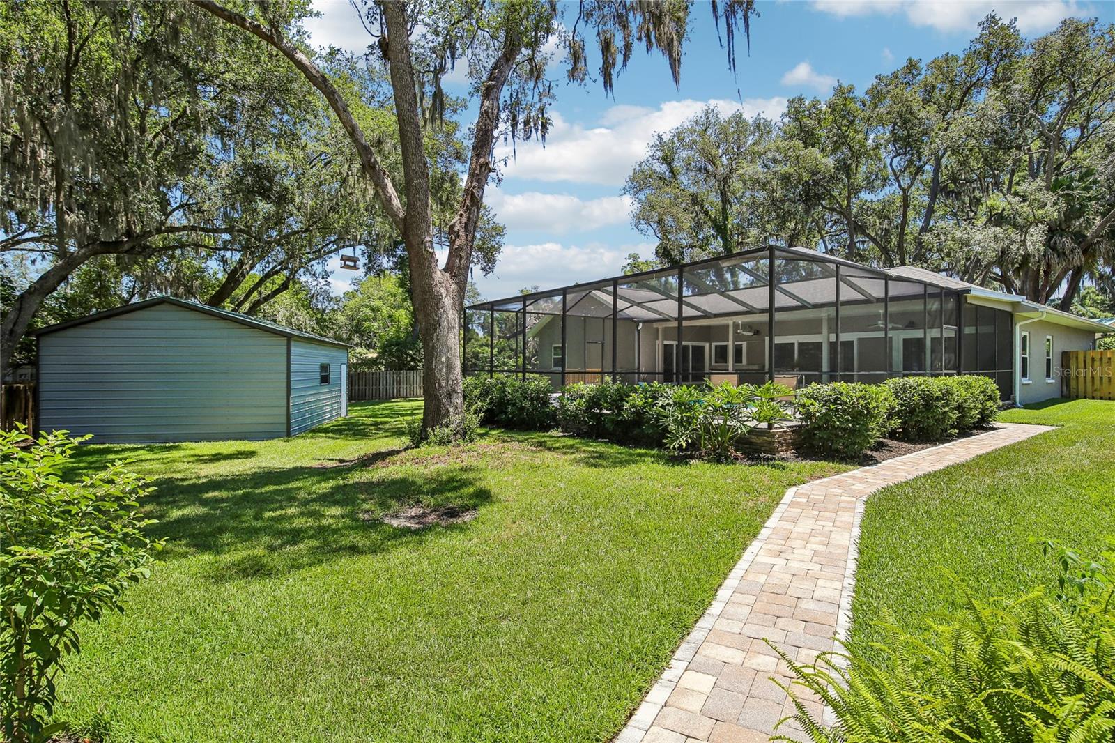 Paved walkway to back yard gazebo and fire pit
