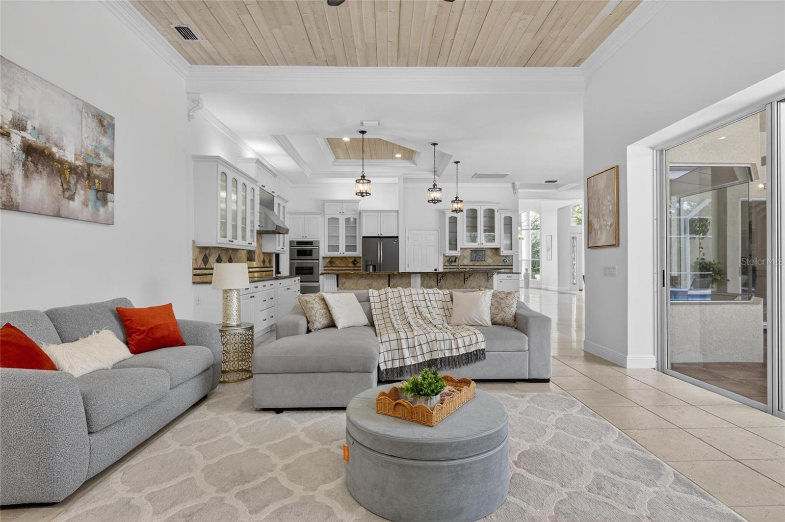 Great room to kitchen, lanai and pool past slider on the right