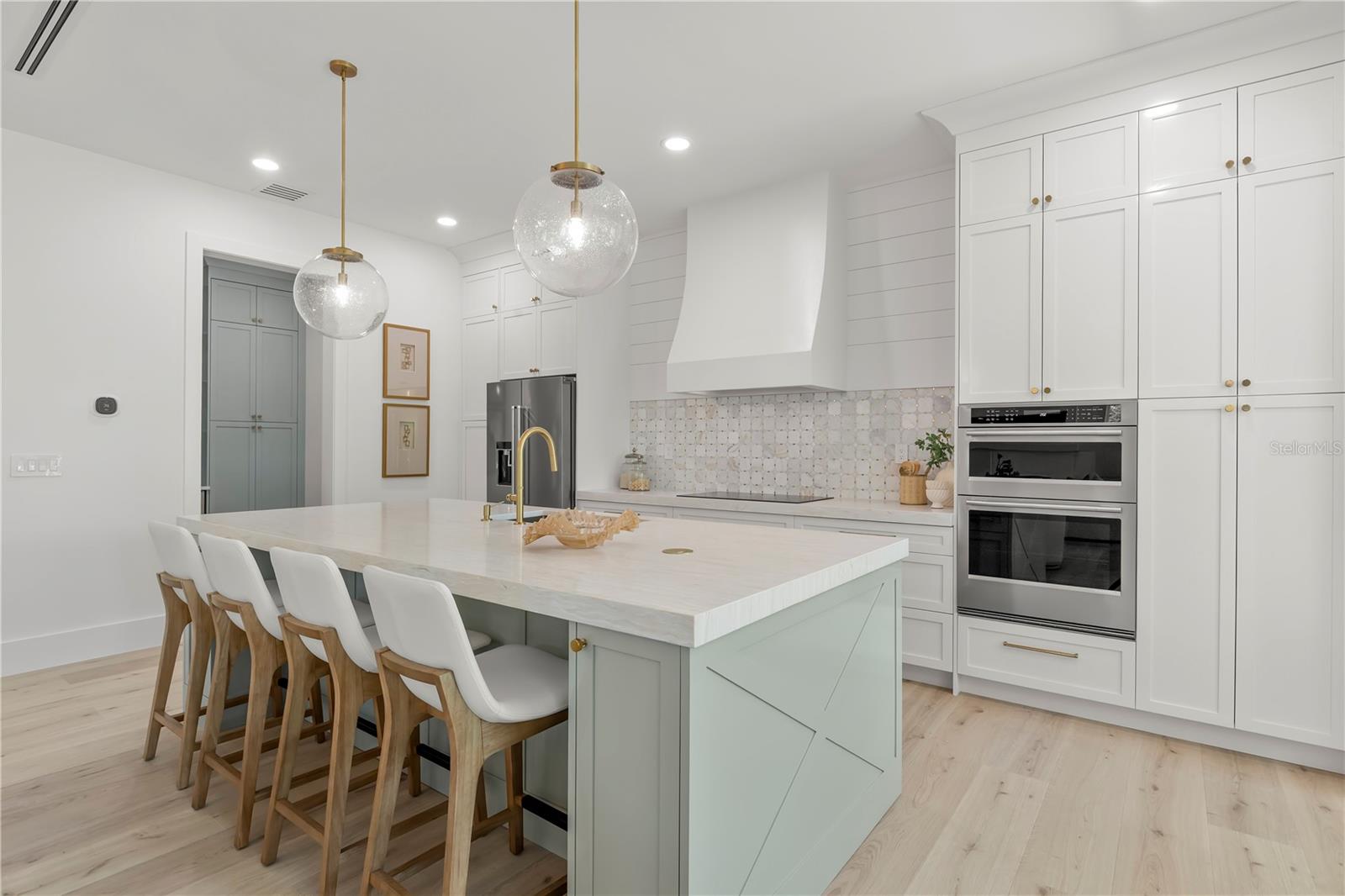 Oversized Island with mitered edge quartz throughout kitchen!
