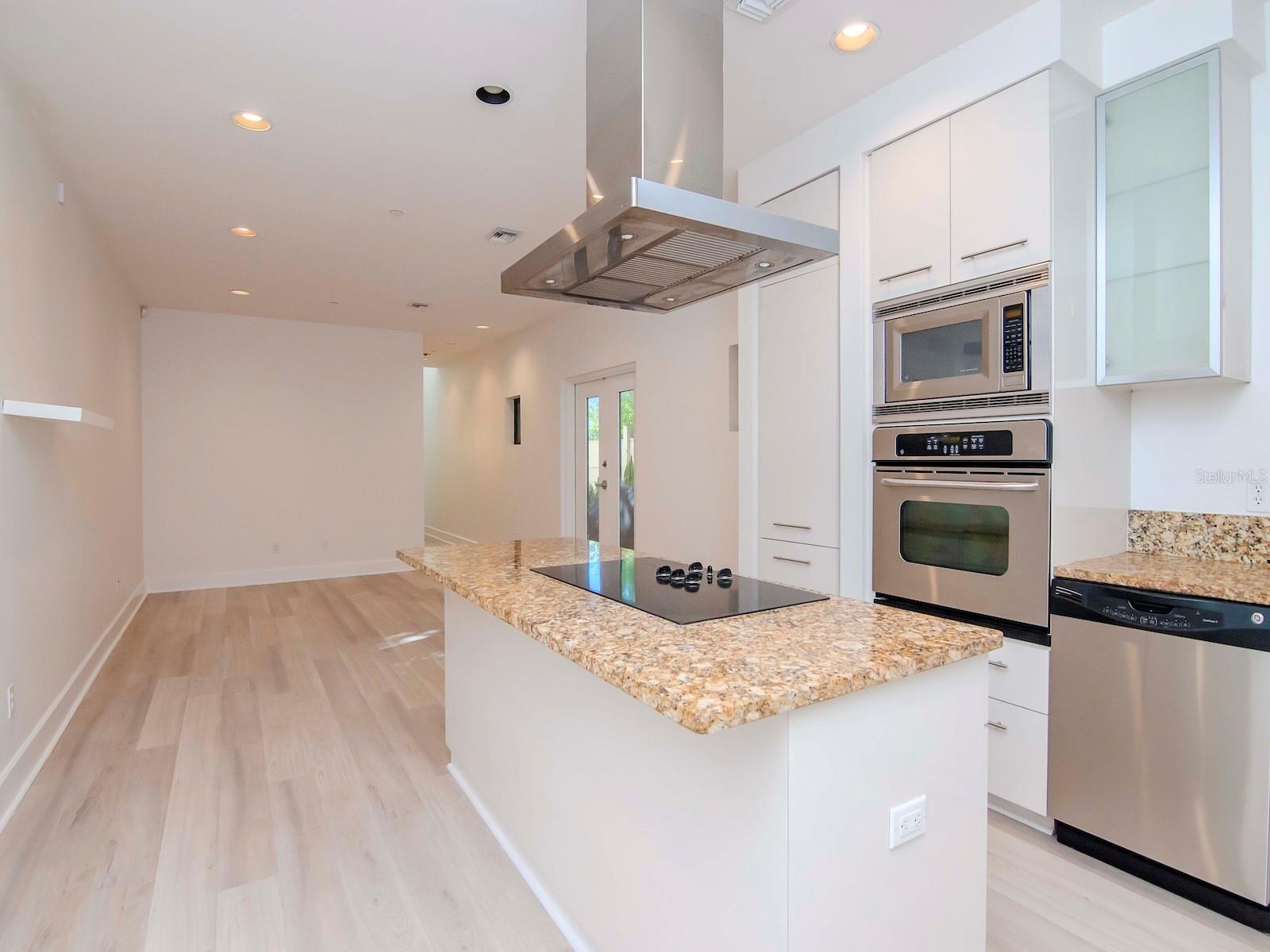 1st level - Open-concept featuring a sleek modern kitchen, dining area, and light-filled living space designed for effortless everyday living and entertaining.