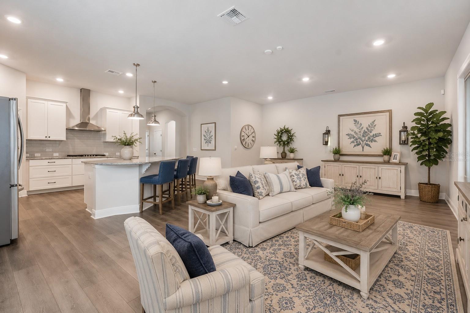 Great room with recessed lighting (virtually staged)