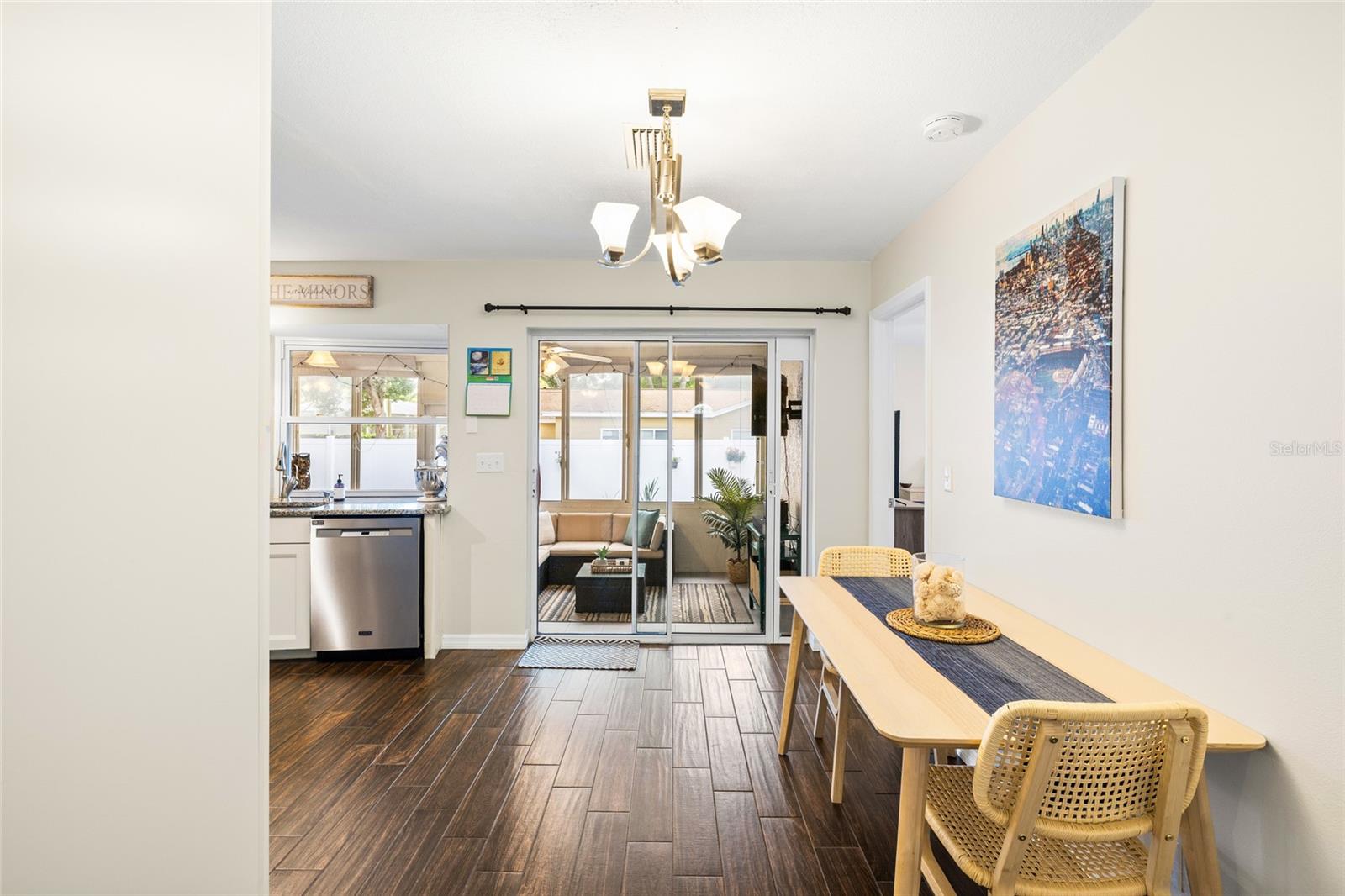 Living and dining space opens to the huge glassed in lanai