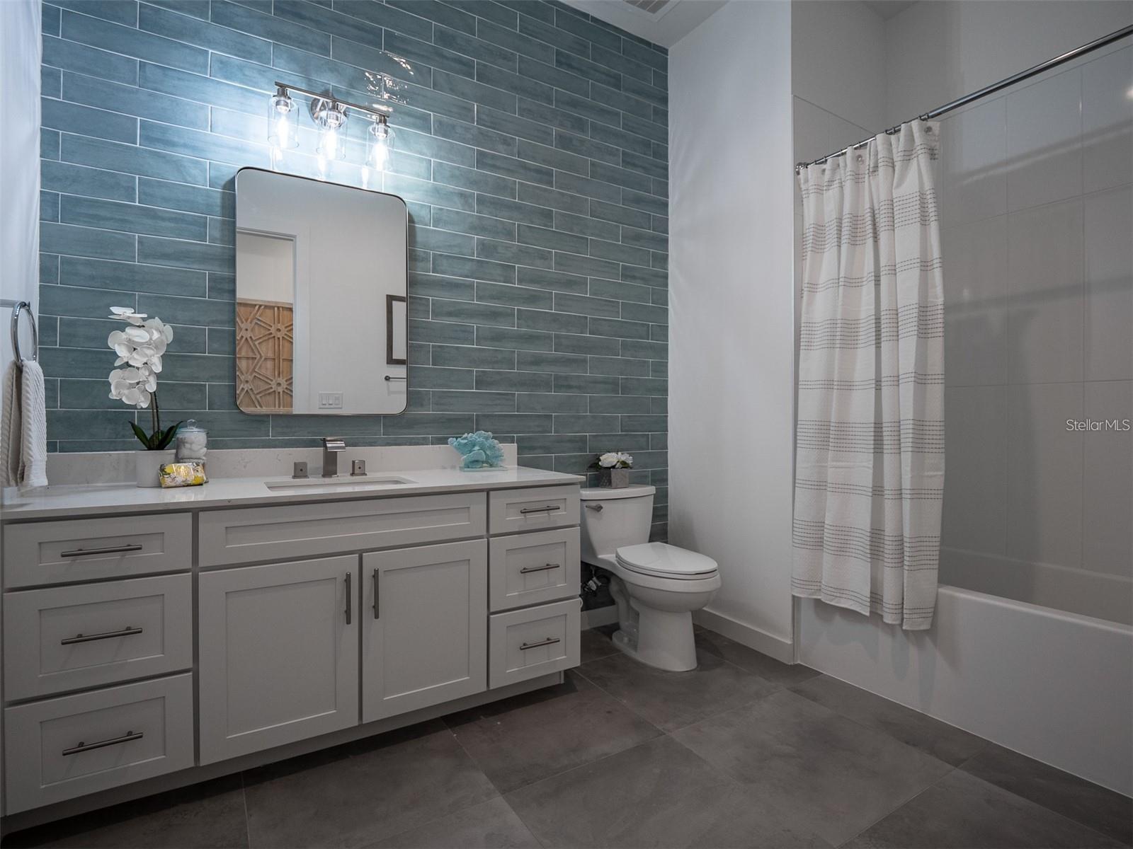 Hall Bathroom with tub and shower and double sinks