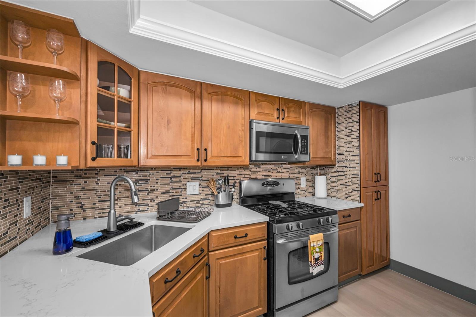 Kitchen with gas range, microwave, new backsplash, new Quartzite counter, sink & faucet!