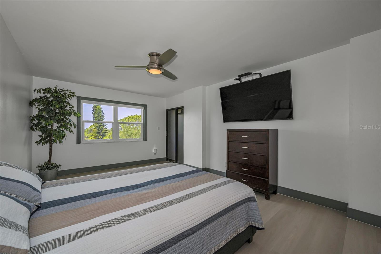 Primary Bedroom, Slider to balcony, new vinyl random plank flooring.