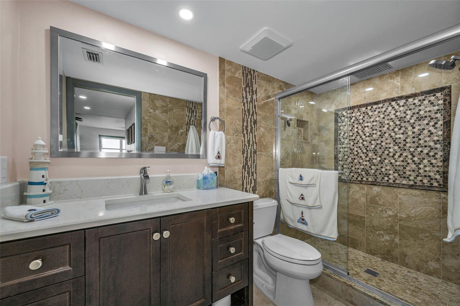 Primary Bathroom with new shower, toilet and vanity, plus overhead lighting.  Gorgeous.