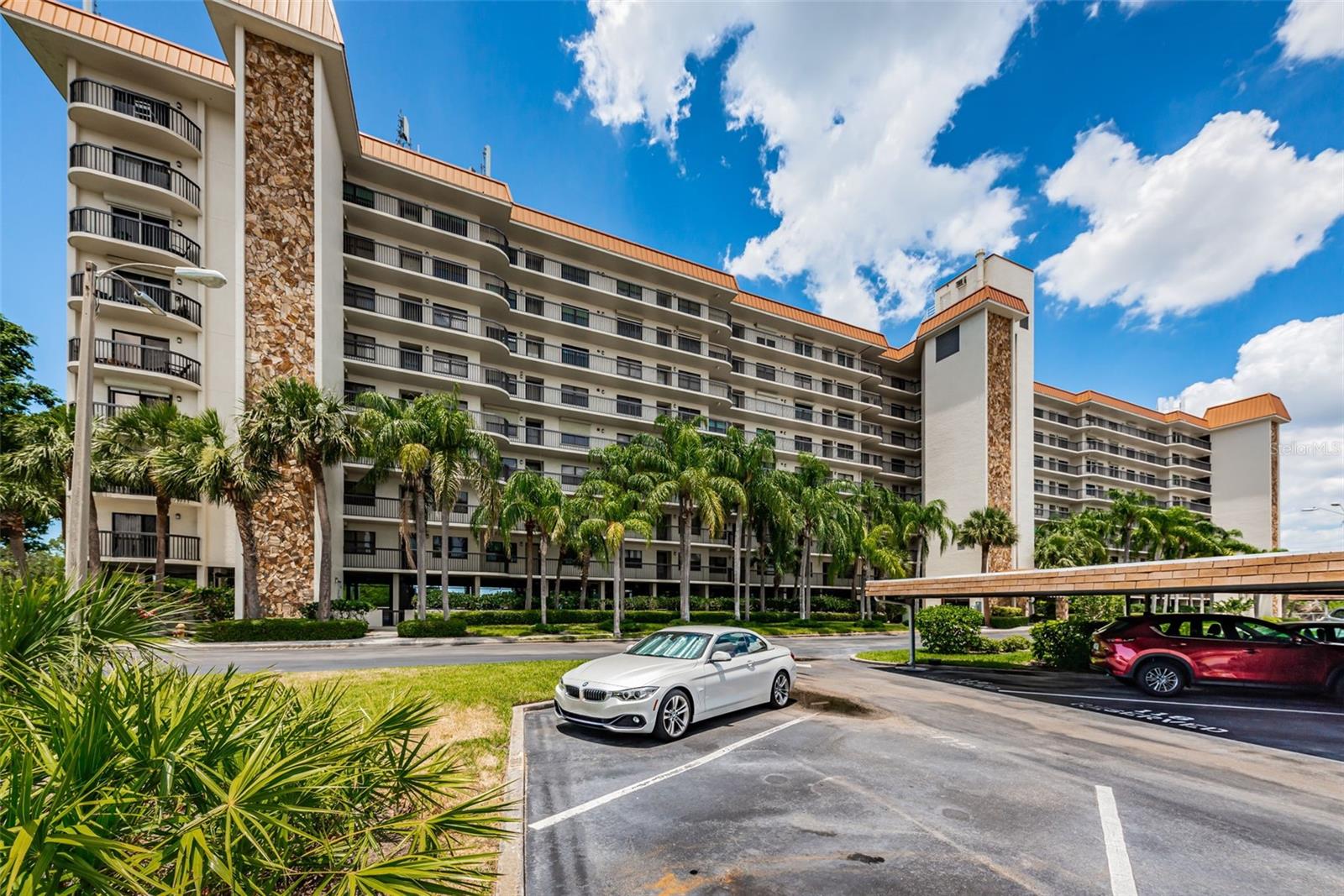 A very Tropical view of Otter Key!  Curved units and balconies on the ends of the building make this a stunning architectural feature; with under building parking and plush Palm Trees!