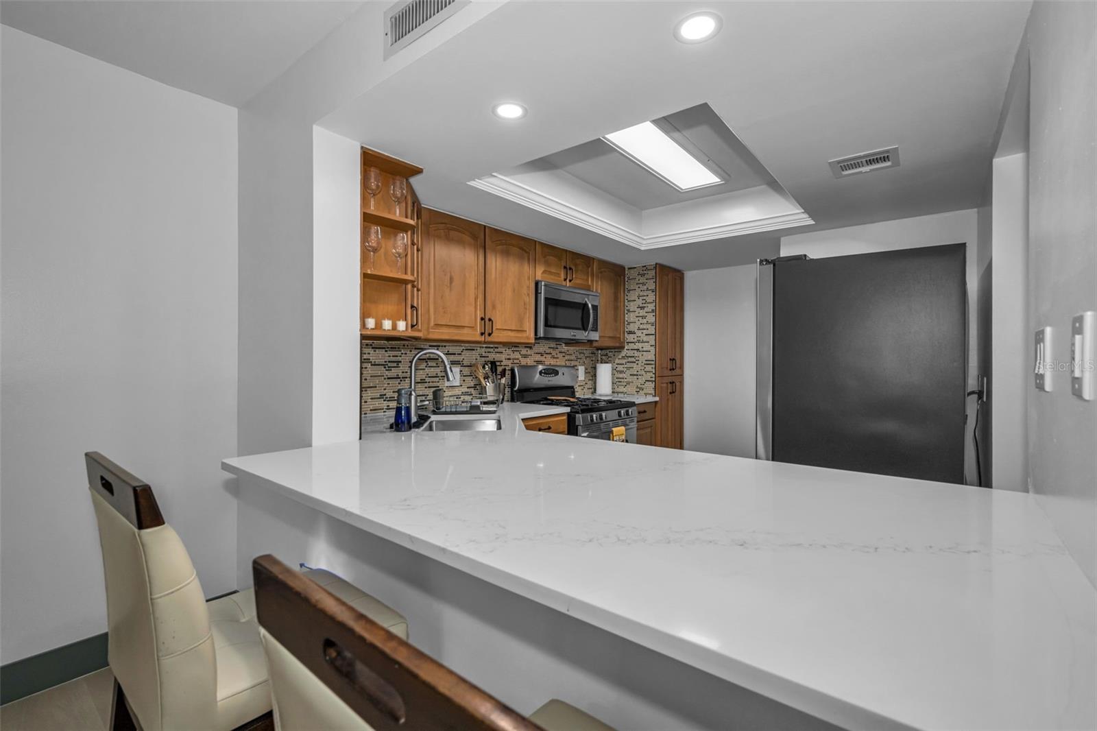 New Quartzite counters in the kitchen and overhead lighting.