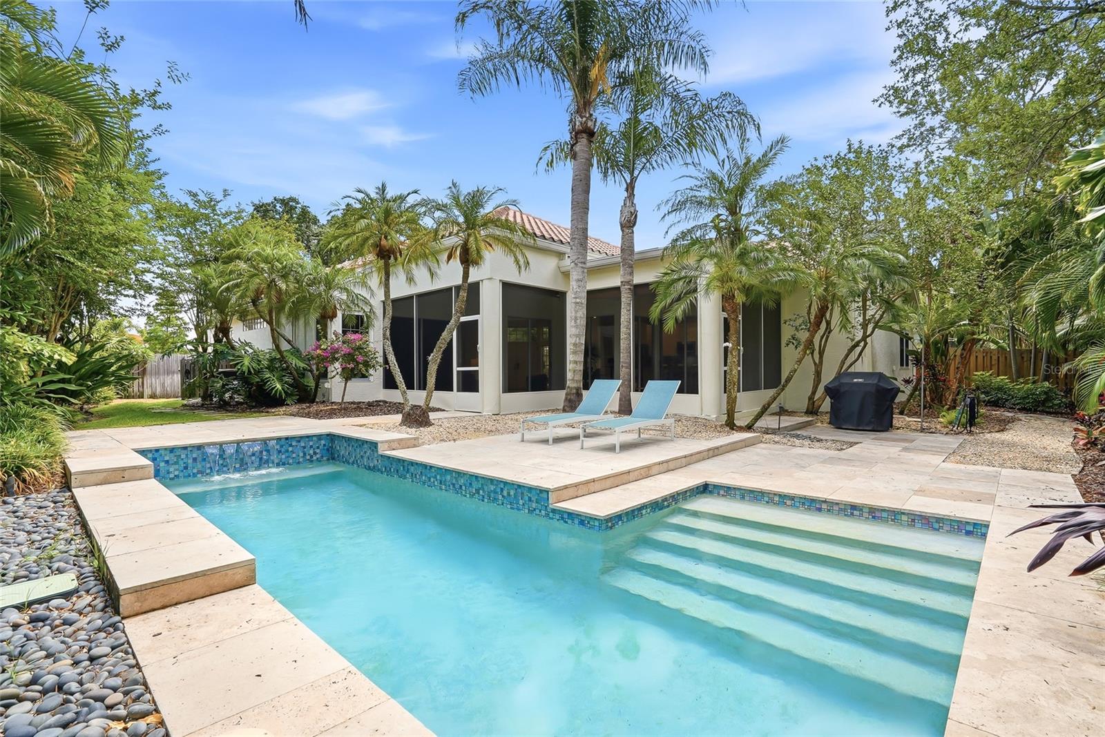 Heated saltwater pool is complemented by a tranquil spillover fountain and a unique jetted bench designed to melt away the day's stresses.