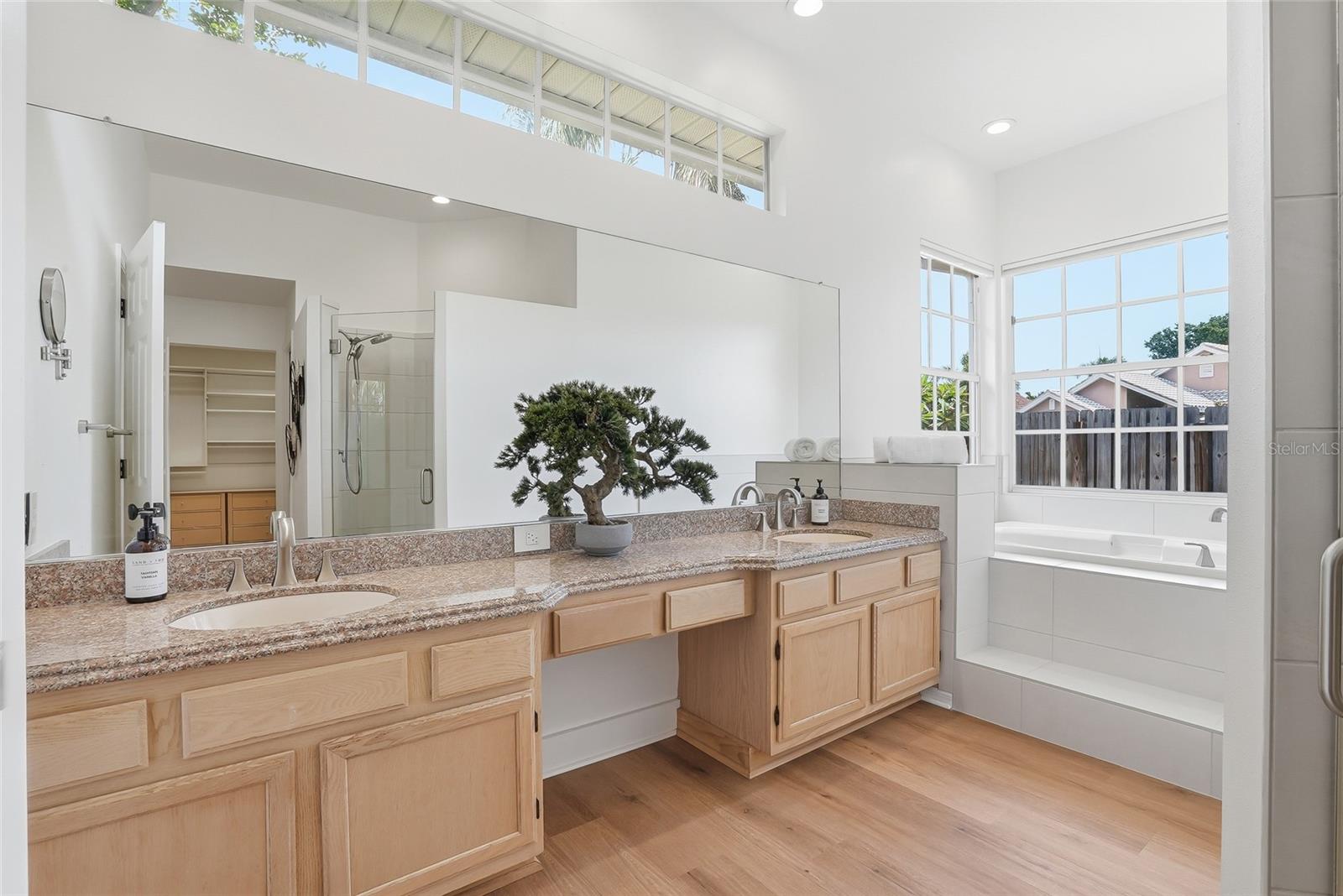 Primary en-suite bathroom has a step-in shower, separate soaking tub and dual vanities.