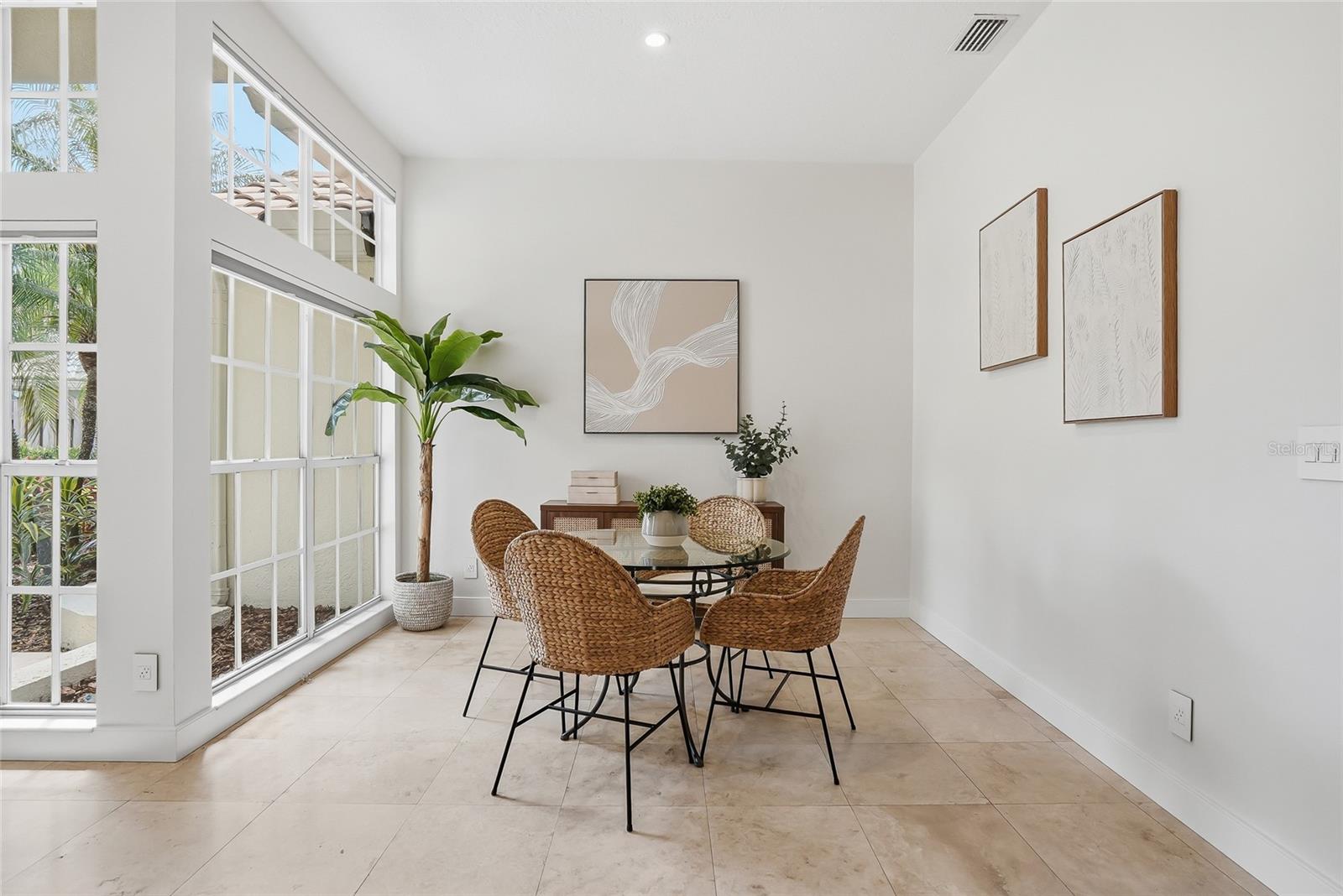 Gather around this brightly lit dining room  with family.