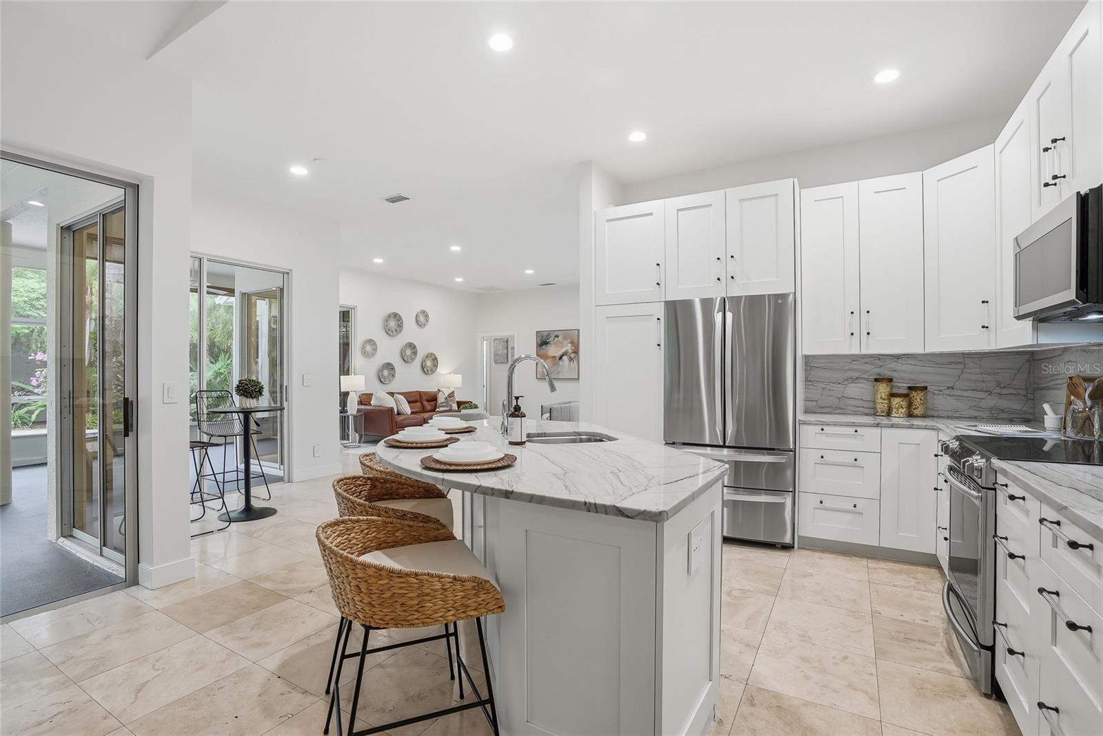 Updated kitchen with stainless steel appliances and stone countertops.