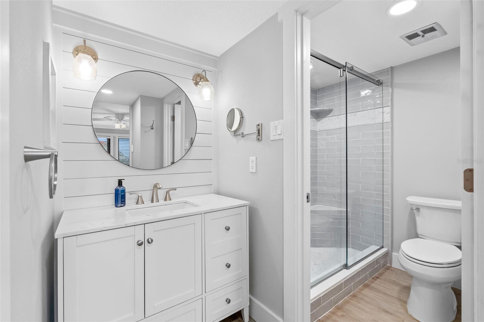 Primary Bathroom features sink area and separate walk-in shower and toilet area