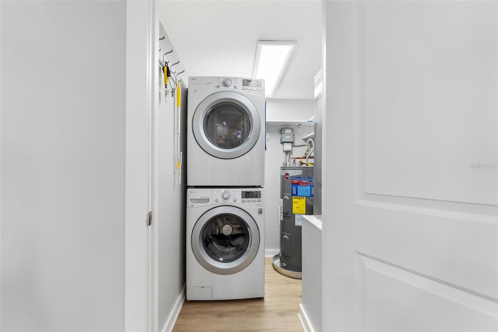 Laundry Room features full size stackable washer and dryer